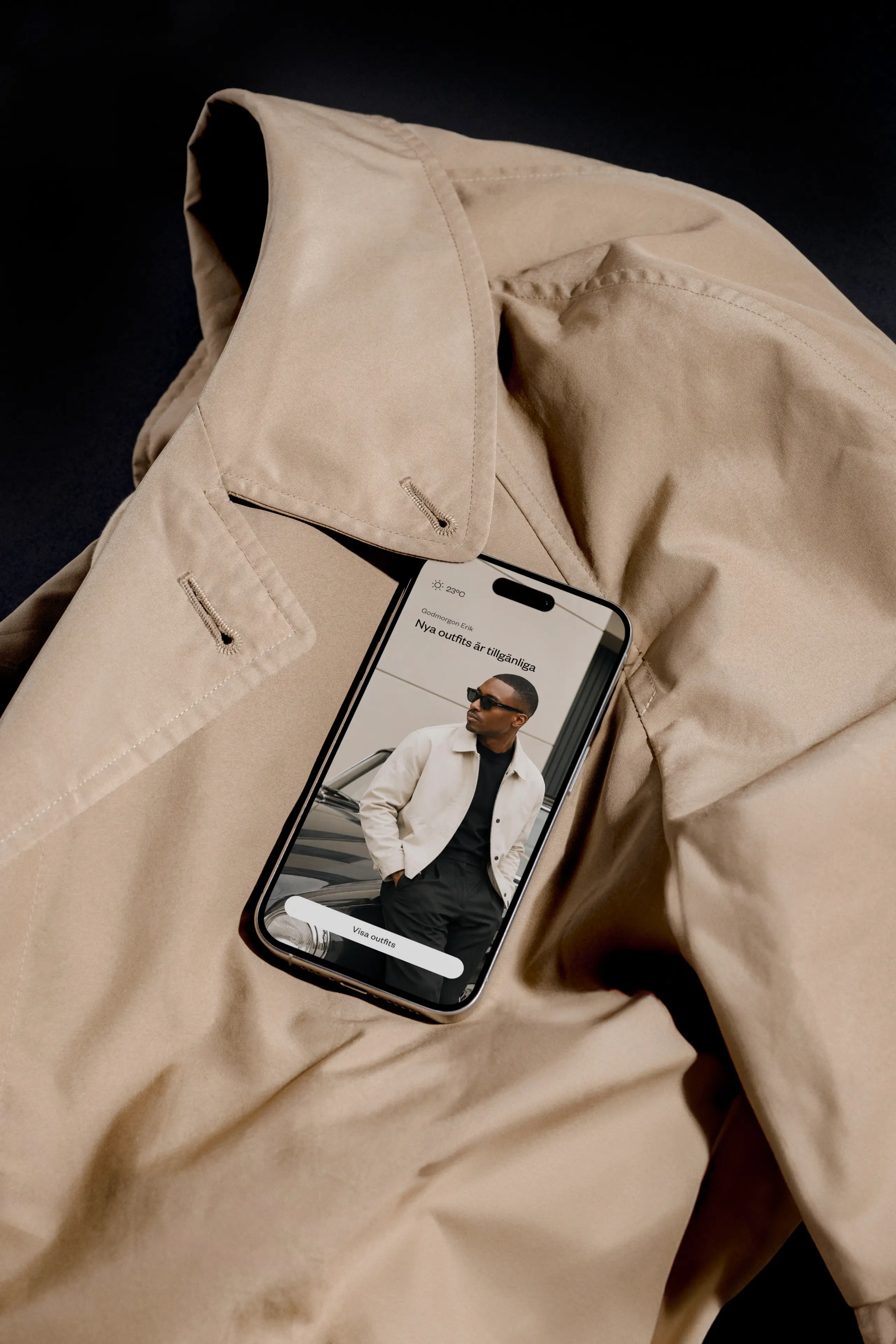 Jacket with a smartphone on it displaying a a man and some UI elements