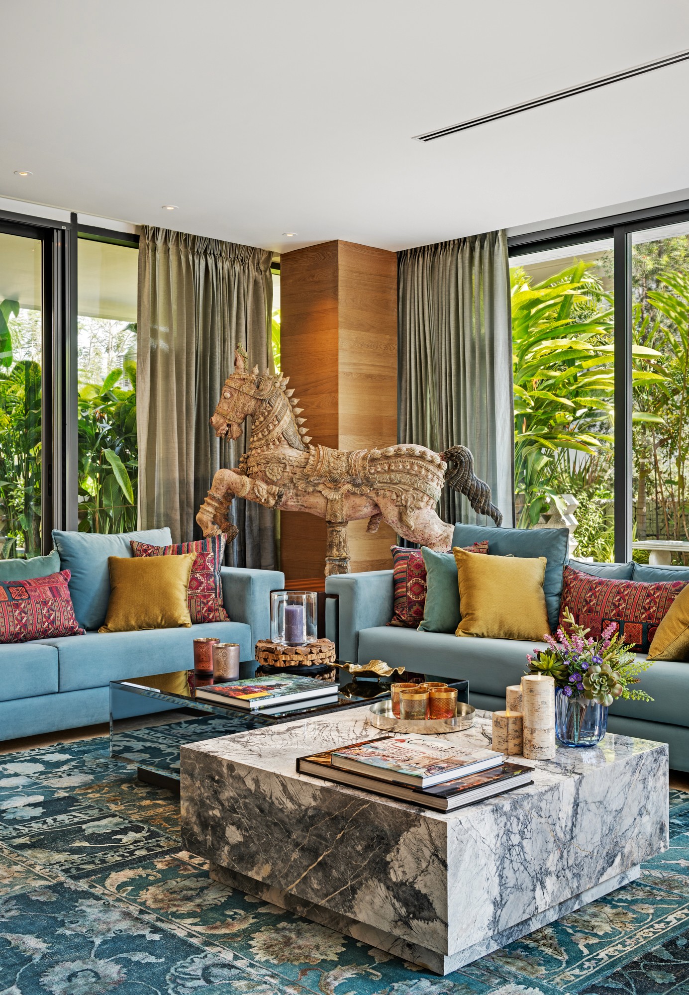 Cozy orange armchair and sofa with cushions, plant.