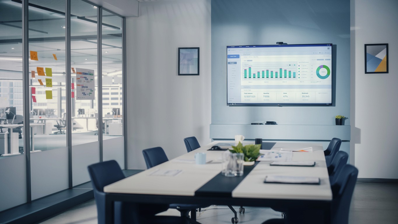 Modern meeting room with a display screen showing a wireless casting dashboard interface