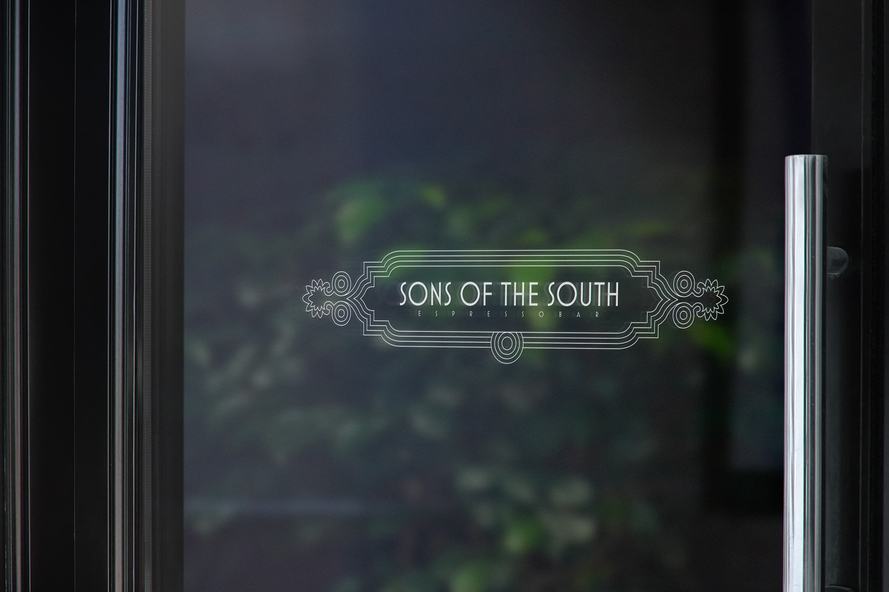 Sons of the South restaurant logo on glass door