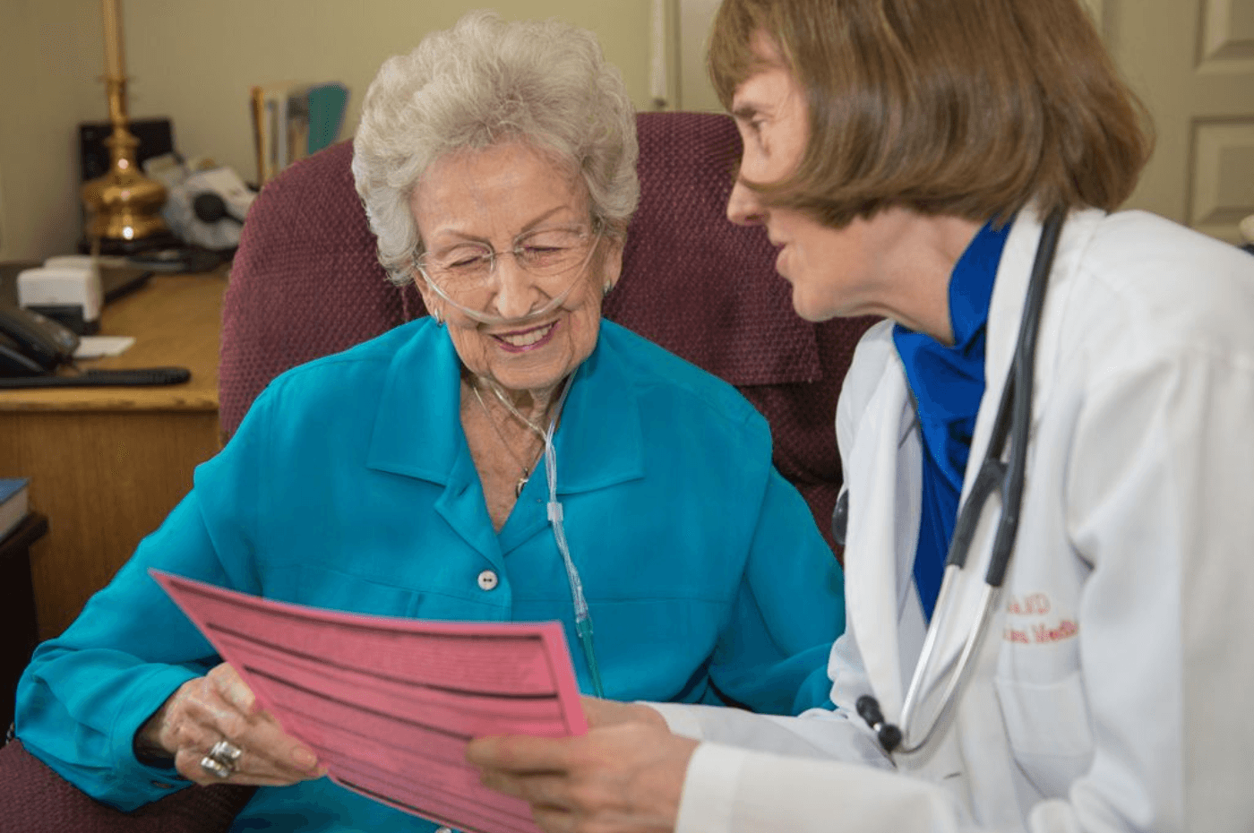 doctor showing elder POST document