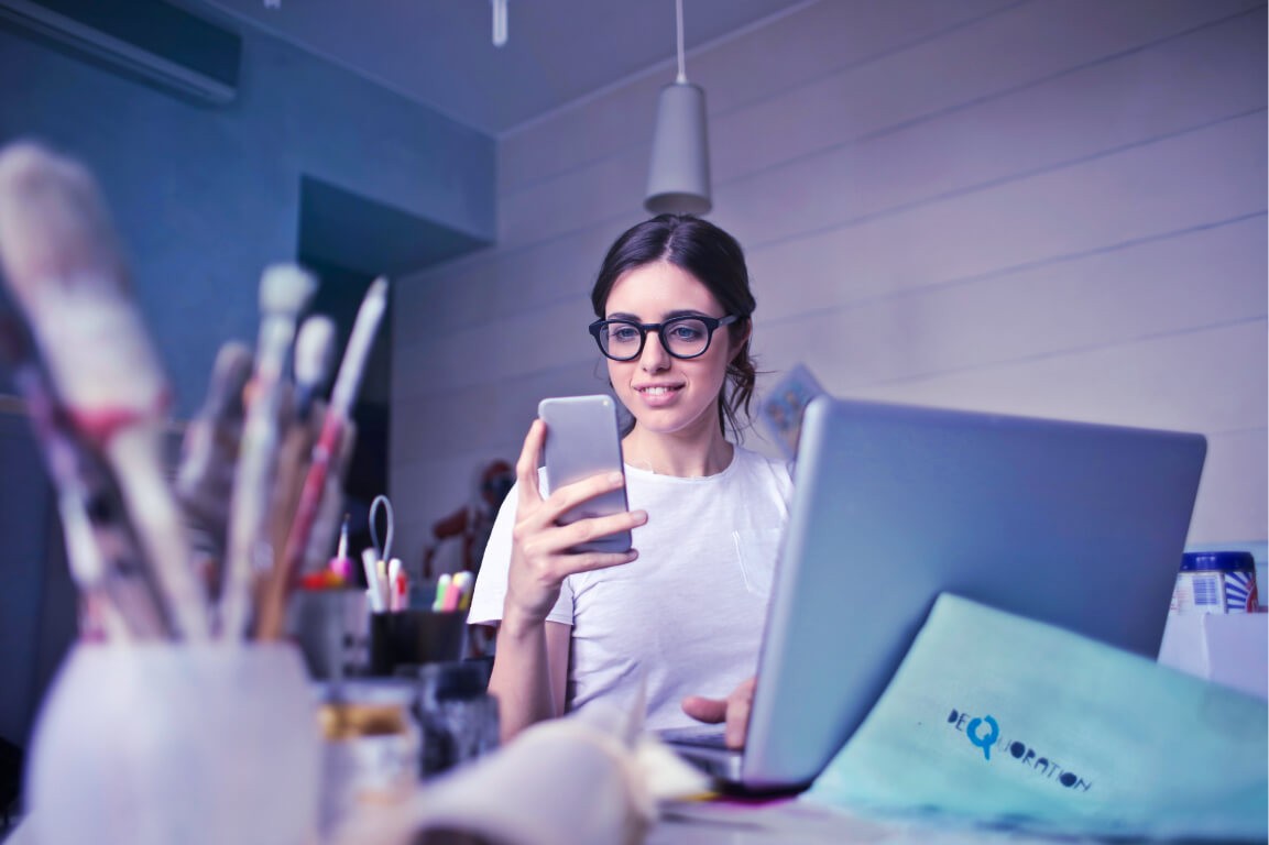 Artist woman brown hair laptop phone glasses