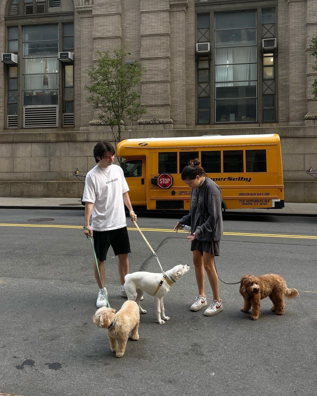 people walking on sidewalk near high rise buildings during daytime