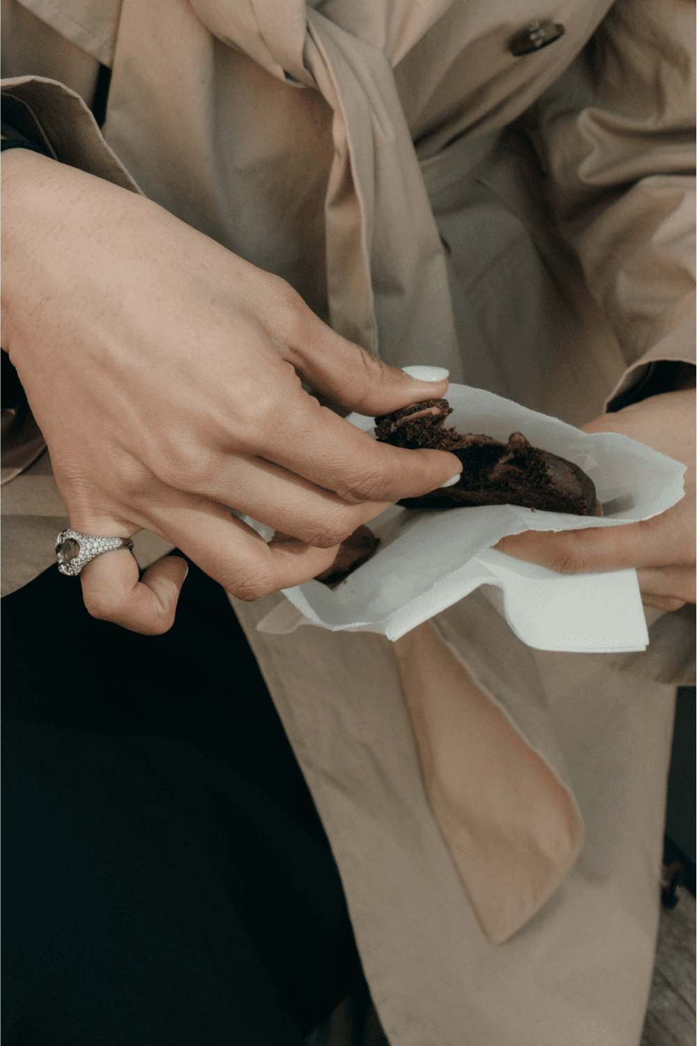 A young man in a white tank top sits pensively in dim light. A mounted deer head and an ornate lamp create a somber, reflective atmosphere.