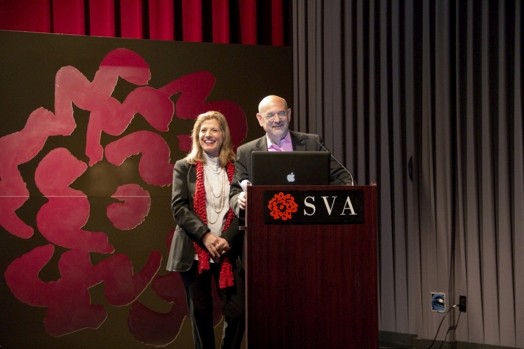 a man and a woman giving a speech from a stand in the "designer as" thesis presentation