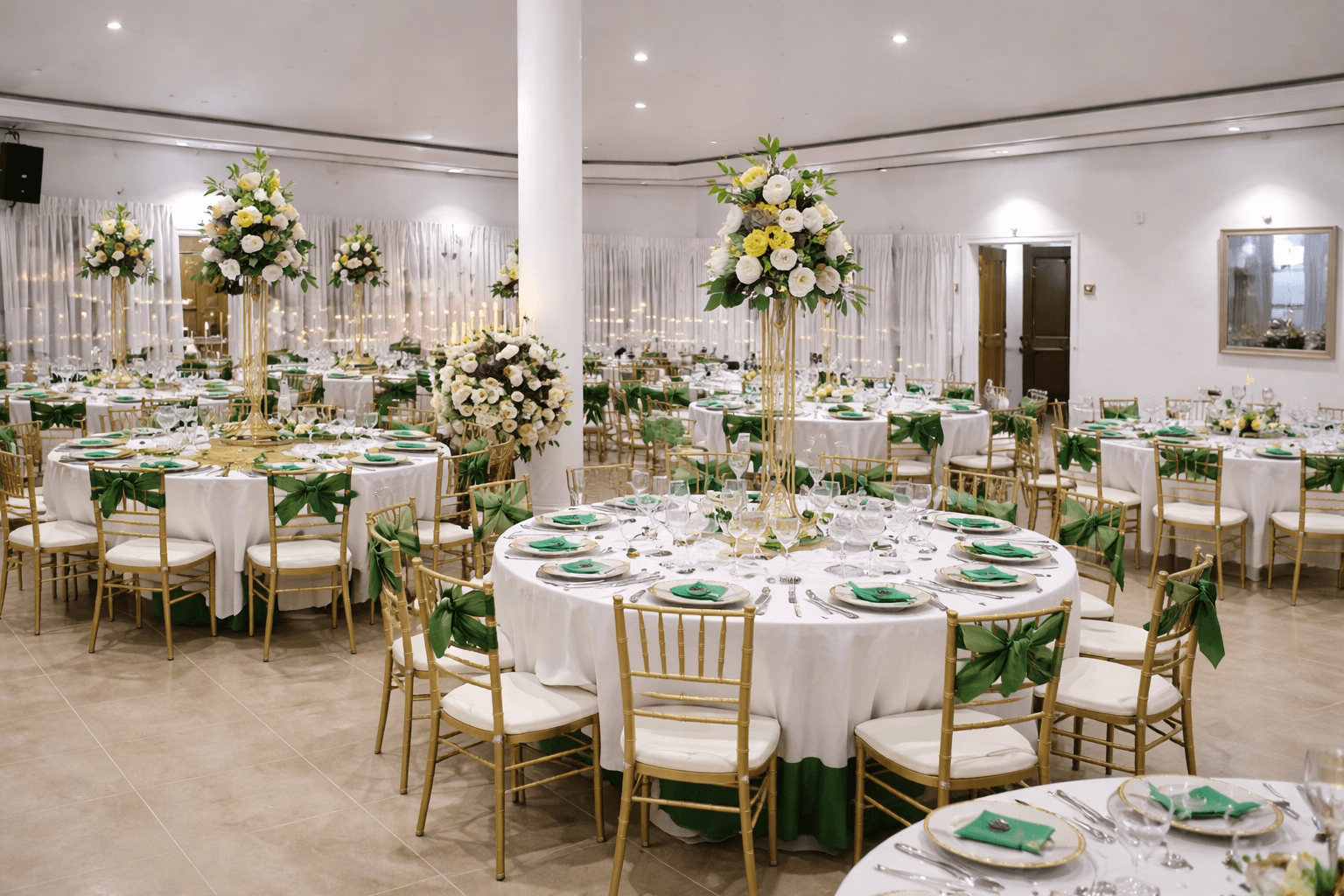 A beautifully set dining table with white tablecloth, cutlery, and fresh greenery in a cozy, well-lit space.