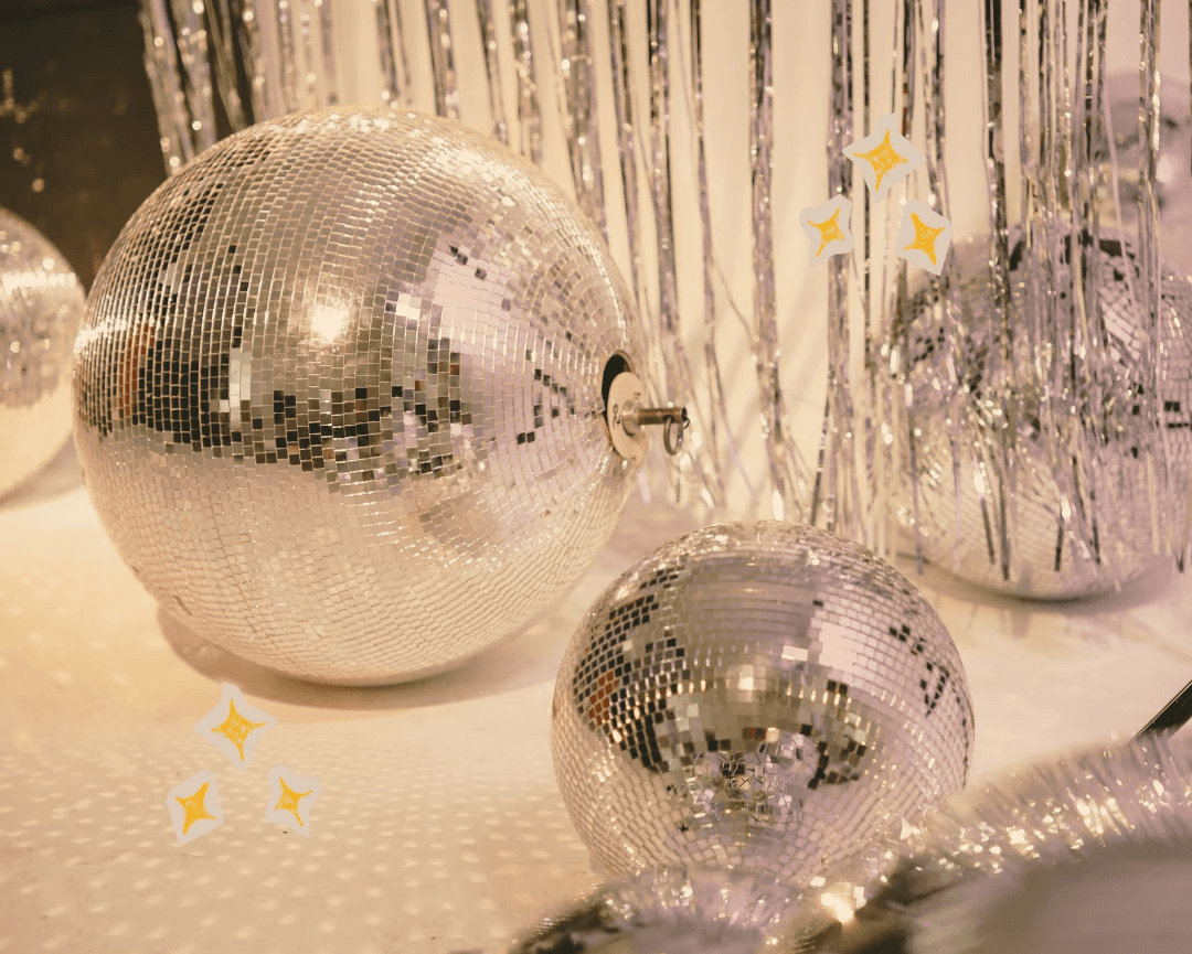 Photo of disco balls on the floor. There are star sticker over the image.