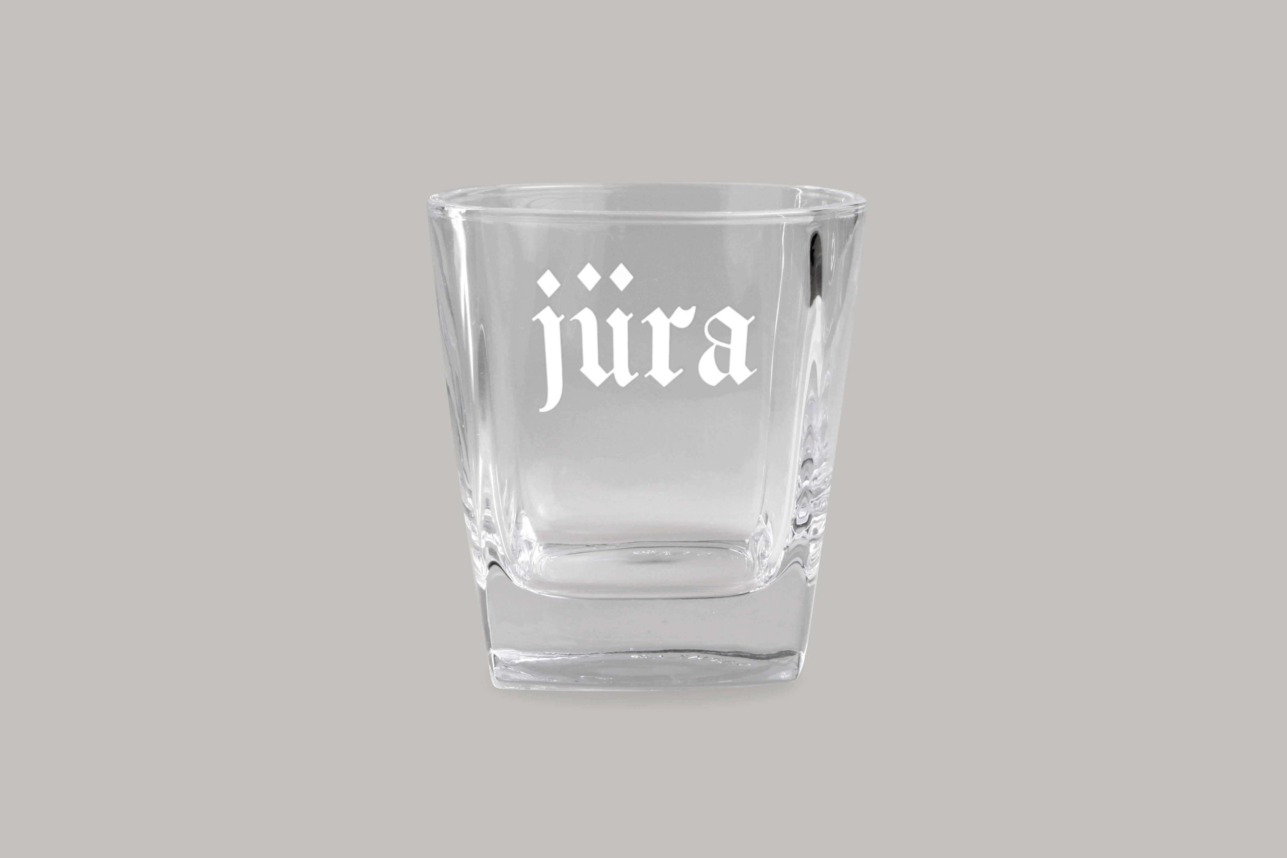 Custom branded glass with Jüradamor logo featuring gothic typography and minimalist merchandise design.