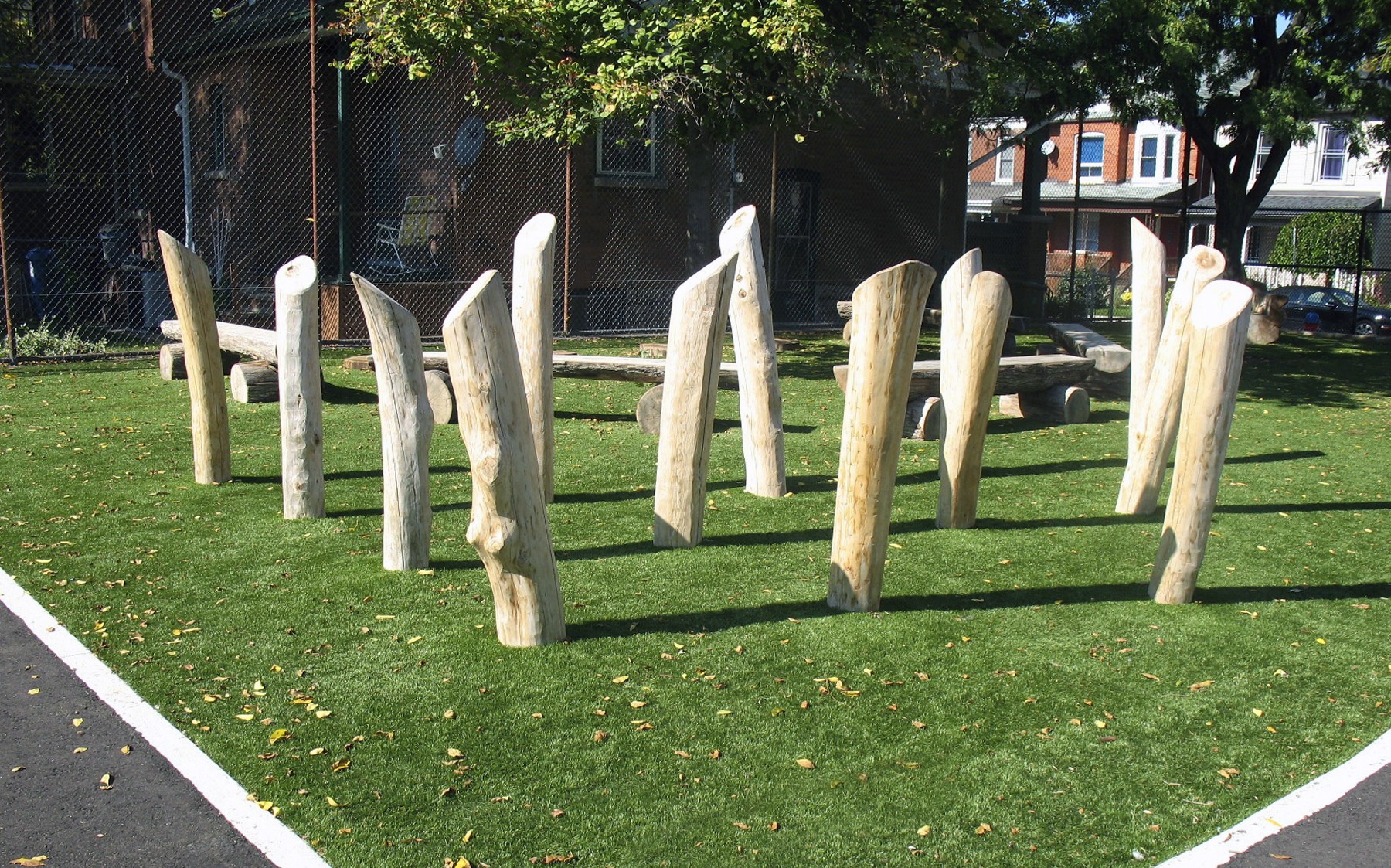 Large artistic white wooden branches pierce the green AGL Grass.