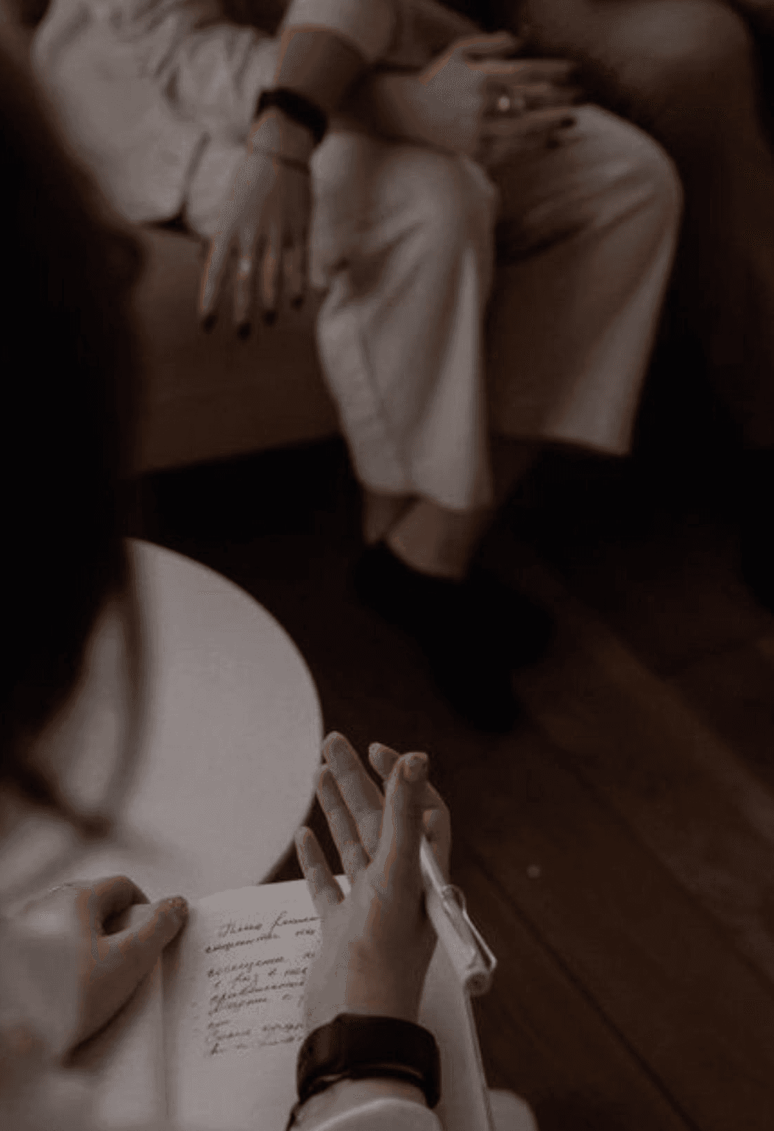 village near cliff and body of water under white clouds