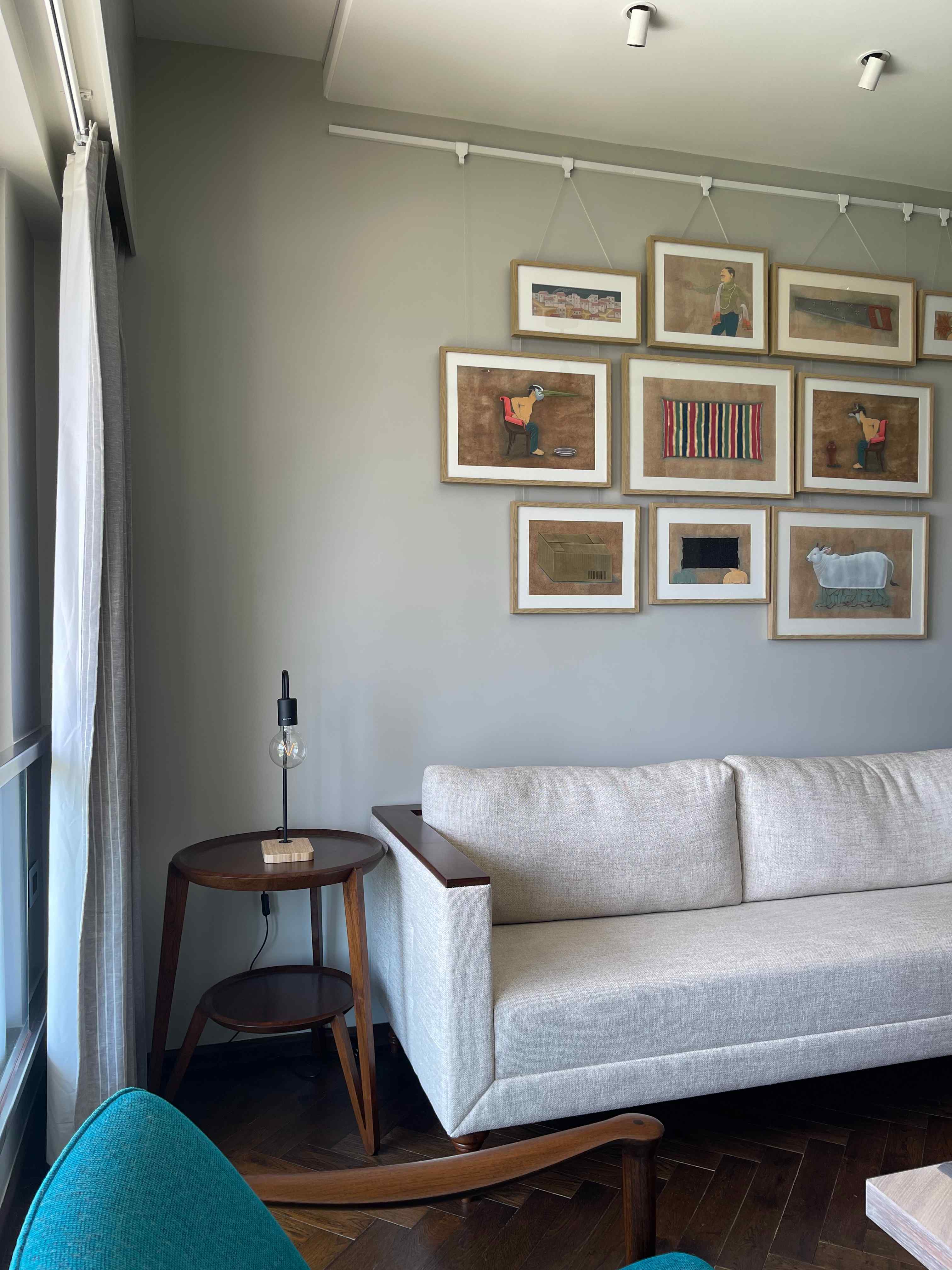 living room with white couch and wall art frames