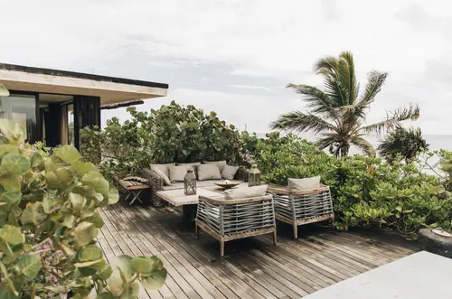 Outdoor ocean view dining at Casa Sastran, Be Tulum, featuring table and chairs.