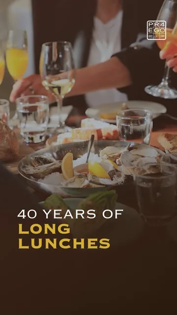 Oysters and glasses on a lunch table, under the words “40 years of long lunches”