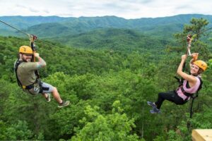 Two friends enjoying the mountaintop ziplines in the Smoky Mountains.