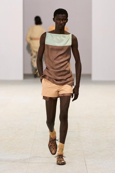 Image may contain Clothing Sleeve Person Vest Adult and Shorts