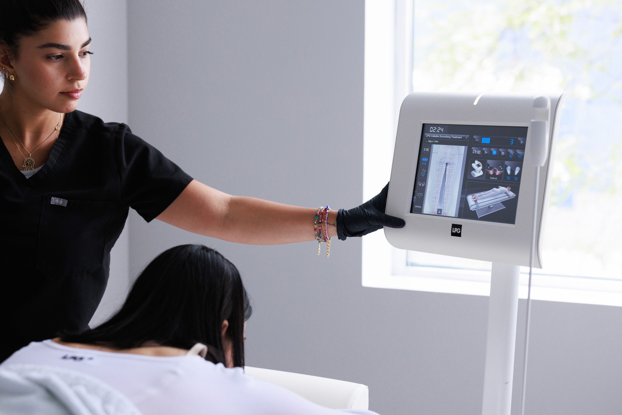 Beautician adjusting the machine for the treatment