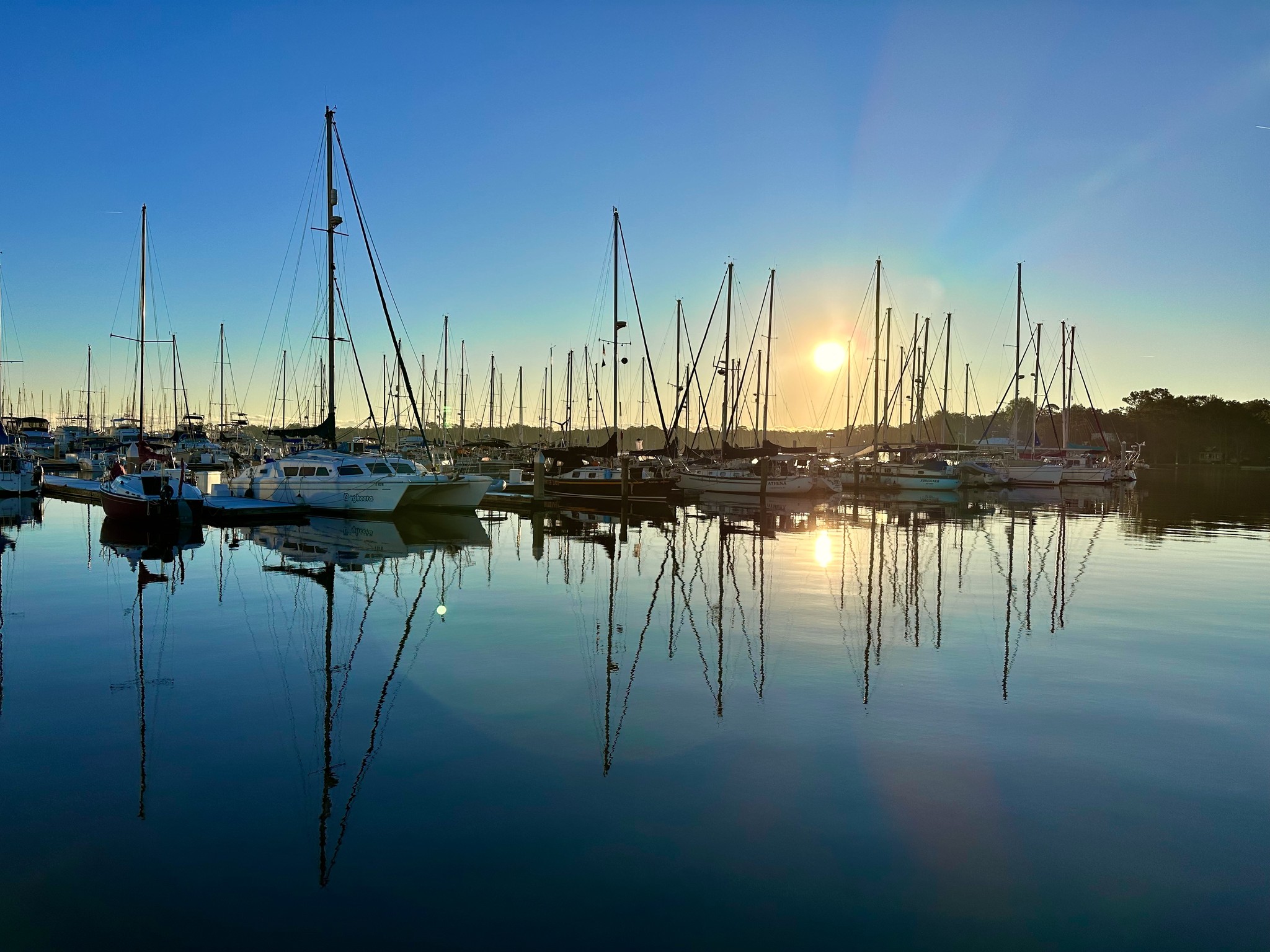 Boats docked at sadler point marina sunset