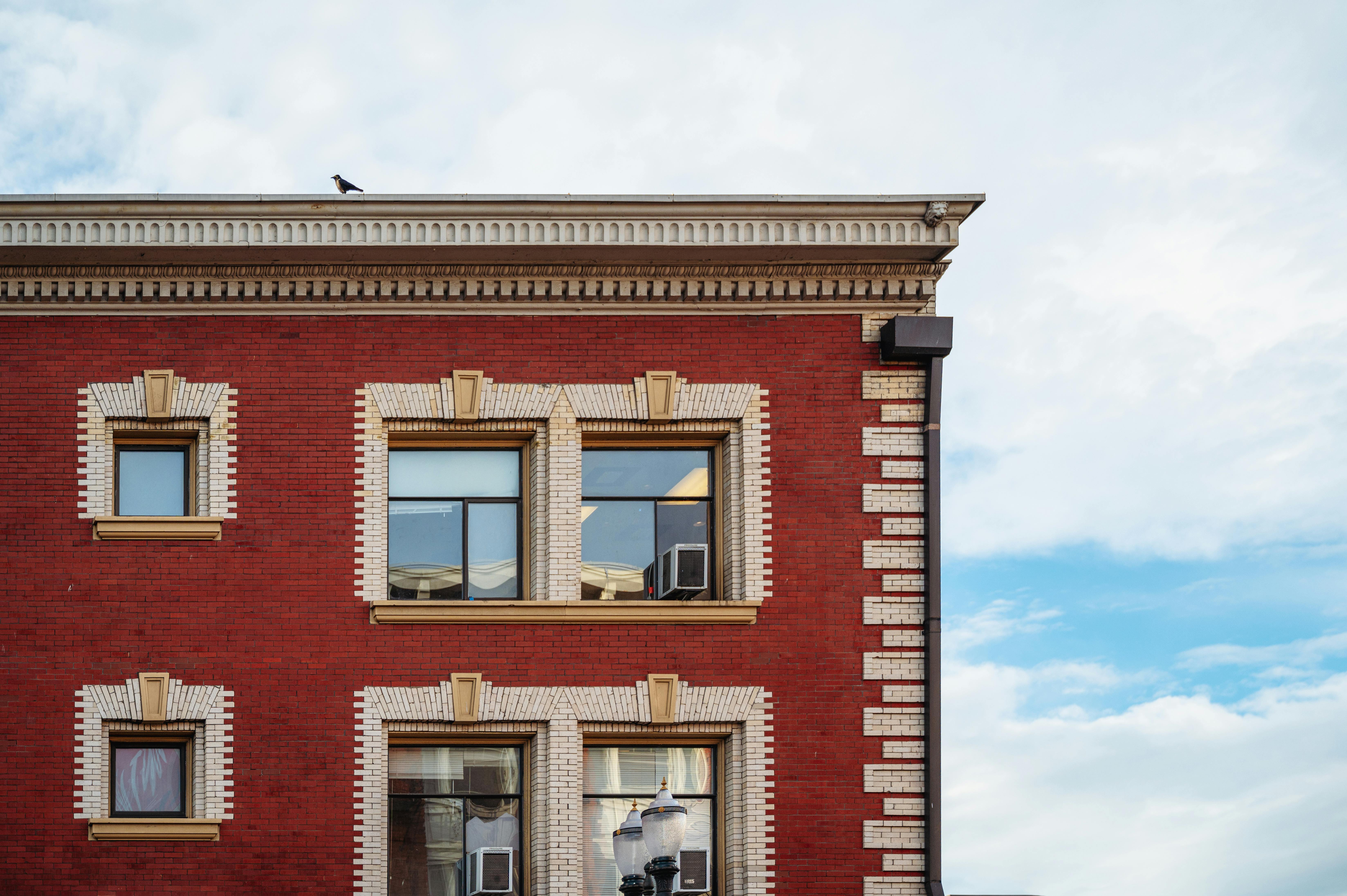 A red brick apartment building with white brick window accents