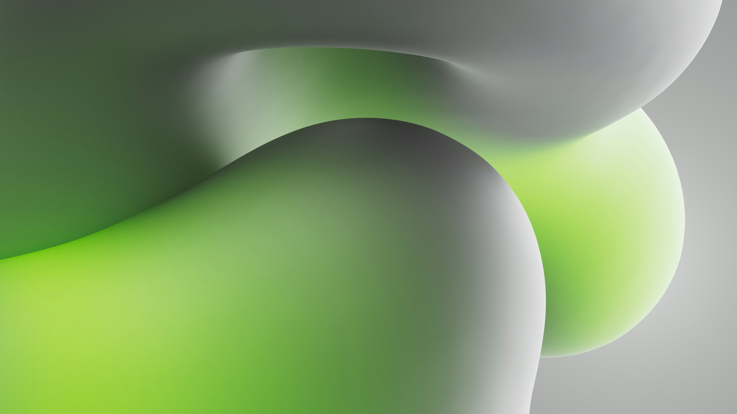 A winding road cuts through rocky terrain, surrounded by patches of green grass and illuminated by sunlight.