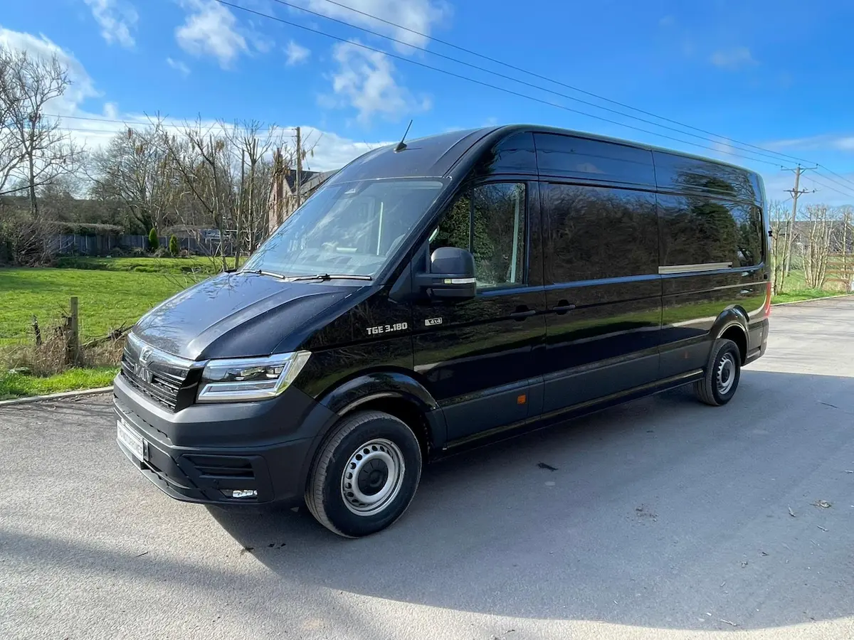 2026 MAN TGE 3.180 4x4 LWB Camper Spec in Obsidian Black, front three-quarter view with TRU Motorhomes plate