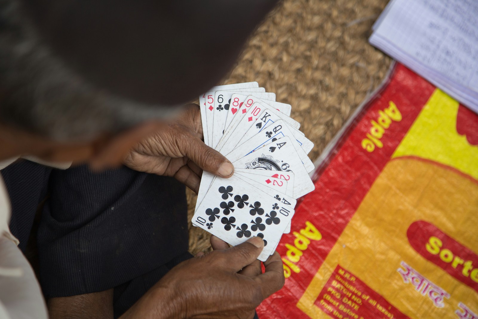 A person holding a deck of playing cards