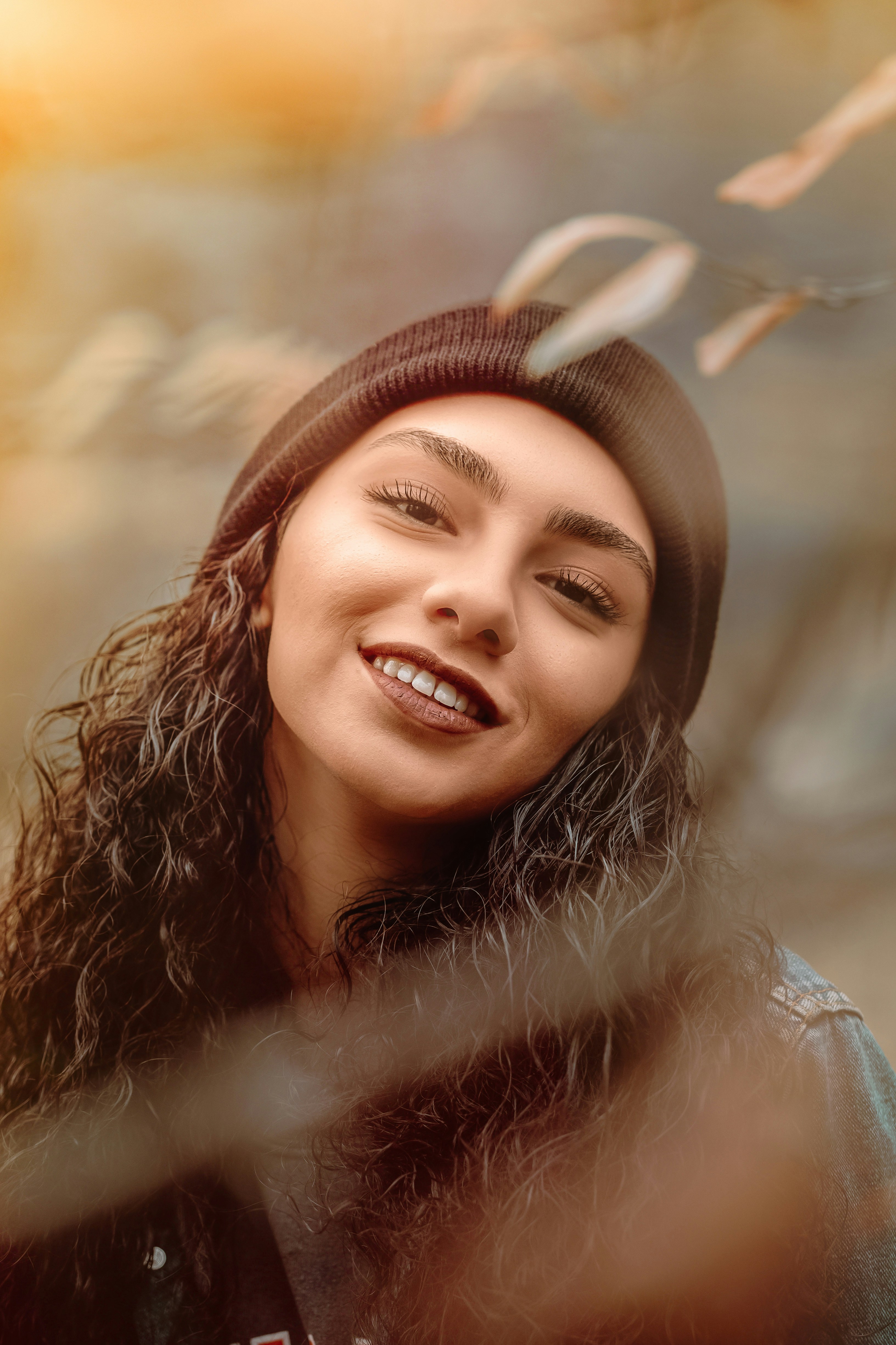 smiling woman wearing black knit cap