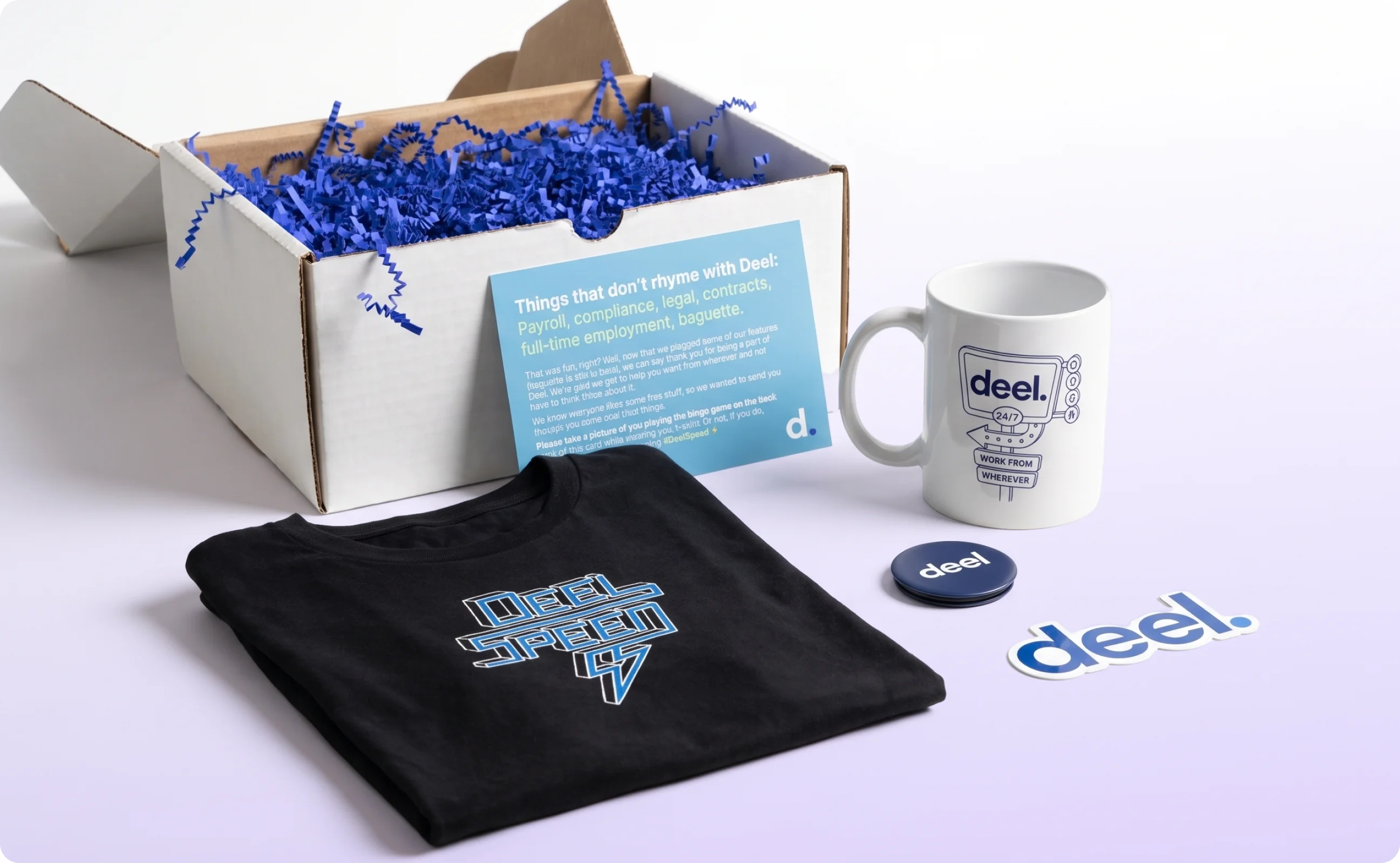 A box, a welcome note, a black shirt, a mug, a popsocket, and a die-cut sticker for Deel new hire swag.