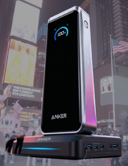 A sleek 3D render of an Anker Prime power bank standing on a charging base in Times Square