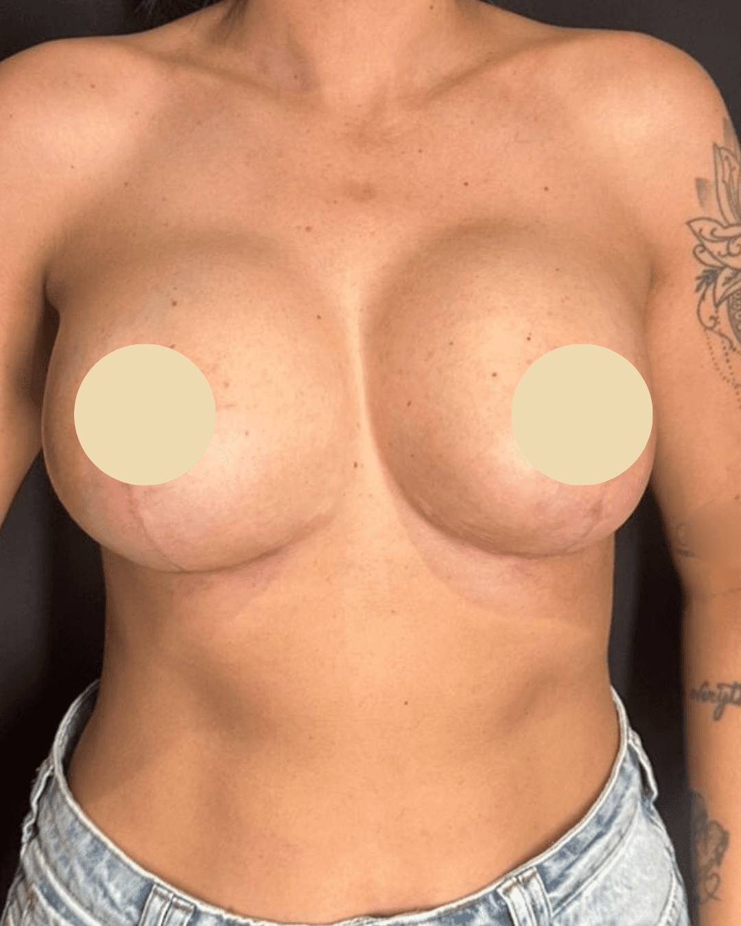 Woman in orange shirt looking up at blue sky