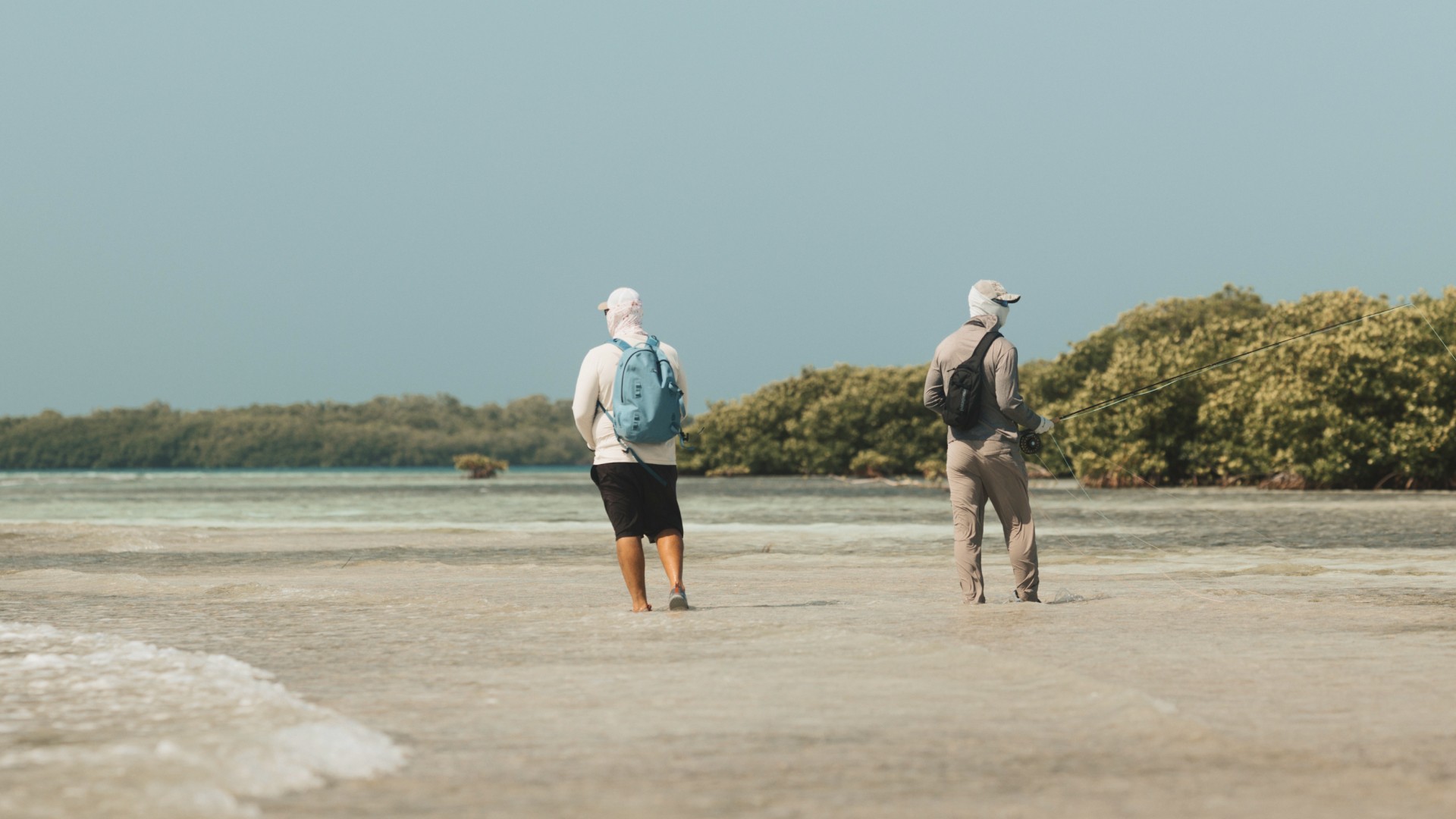 Fly fishing guide Marlon Leslie walking a shallow flat with a saltwater angler