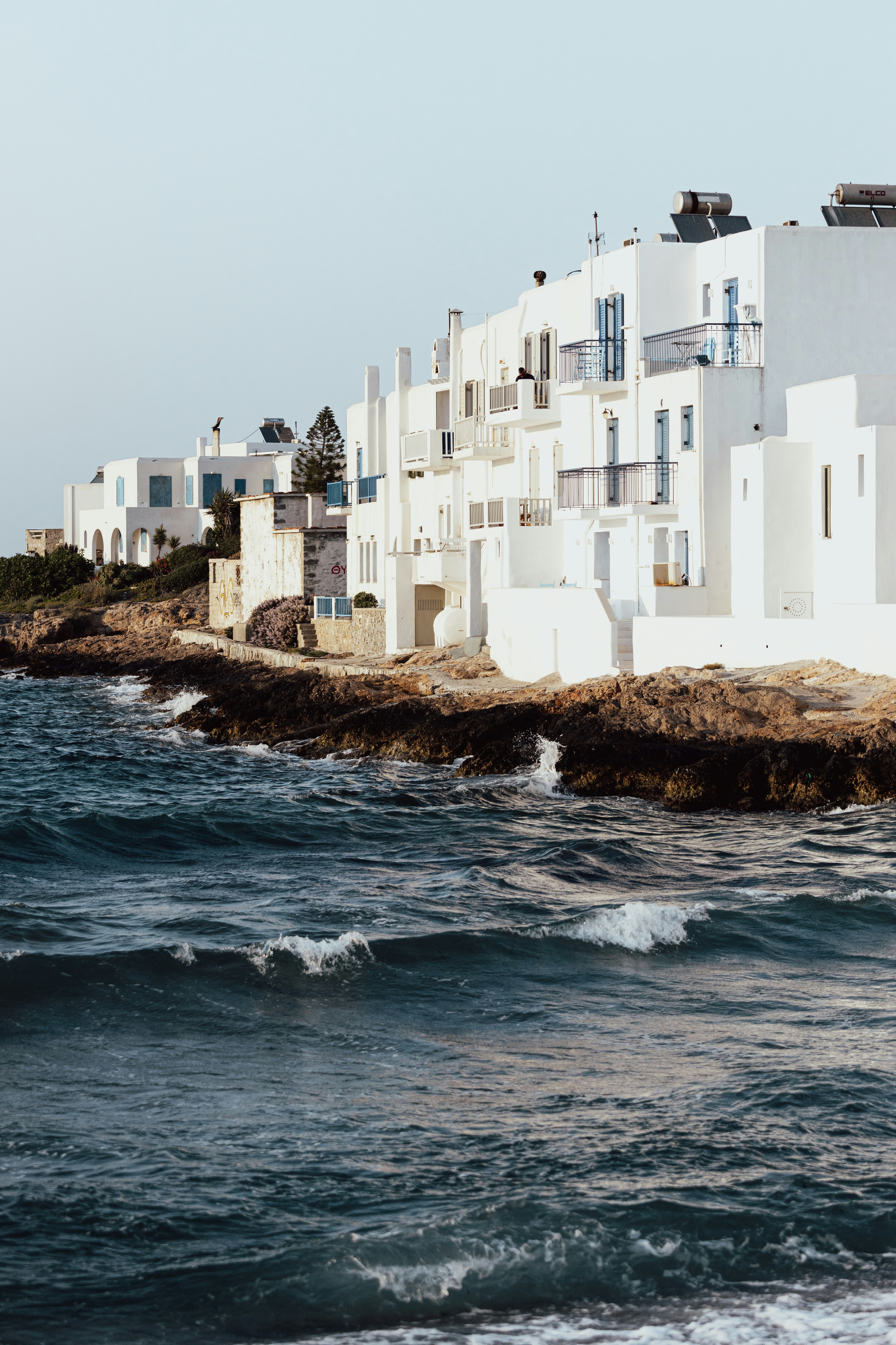 a white building on a rocky shore