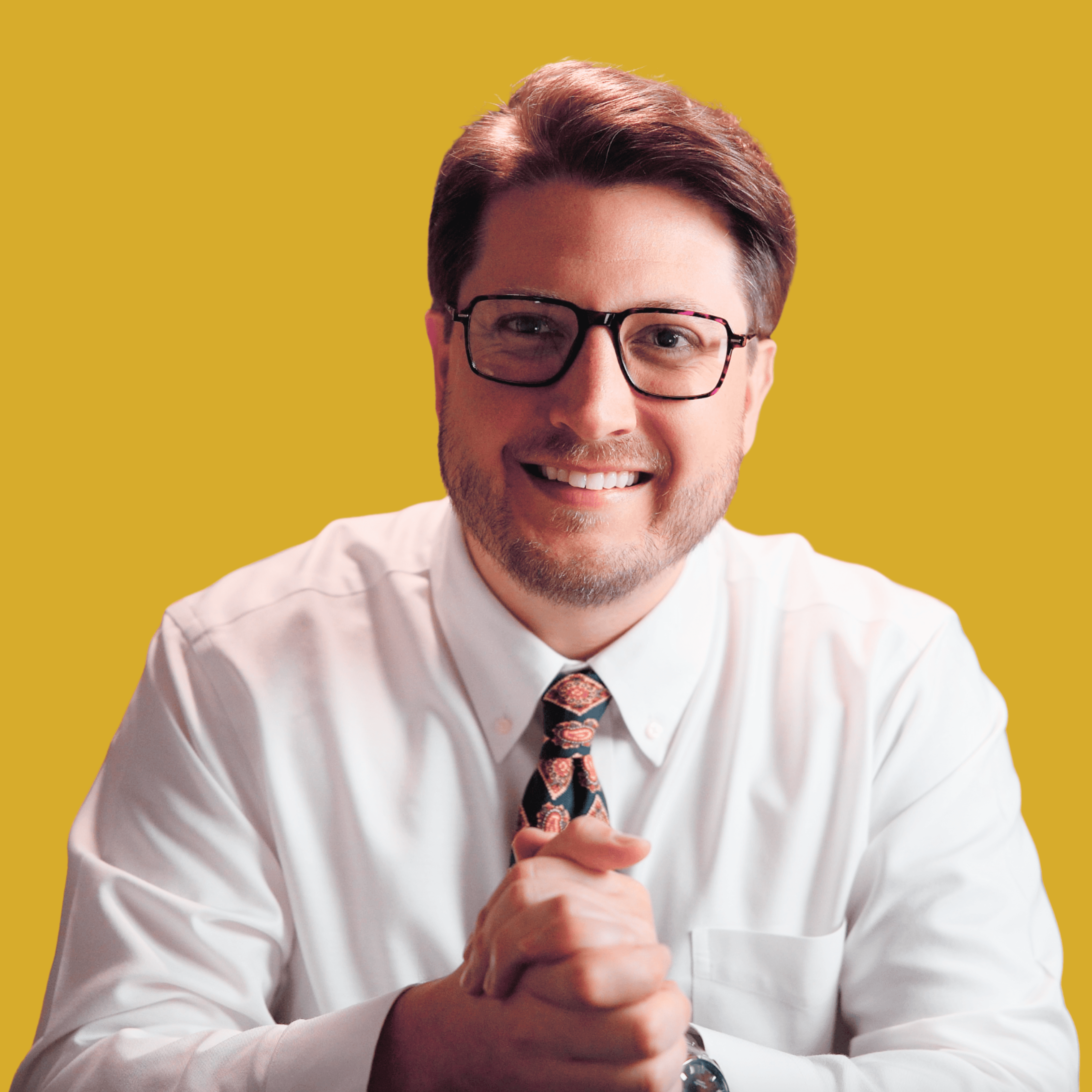 Headshot of Adam Lambert, founder of Narrative Supply, looking towards the left in front of a bright yellow background.