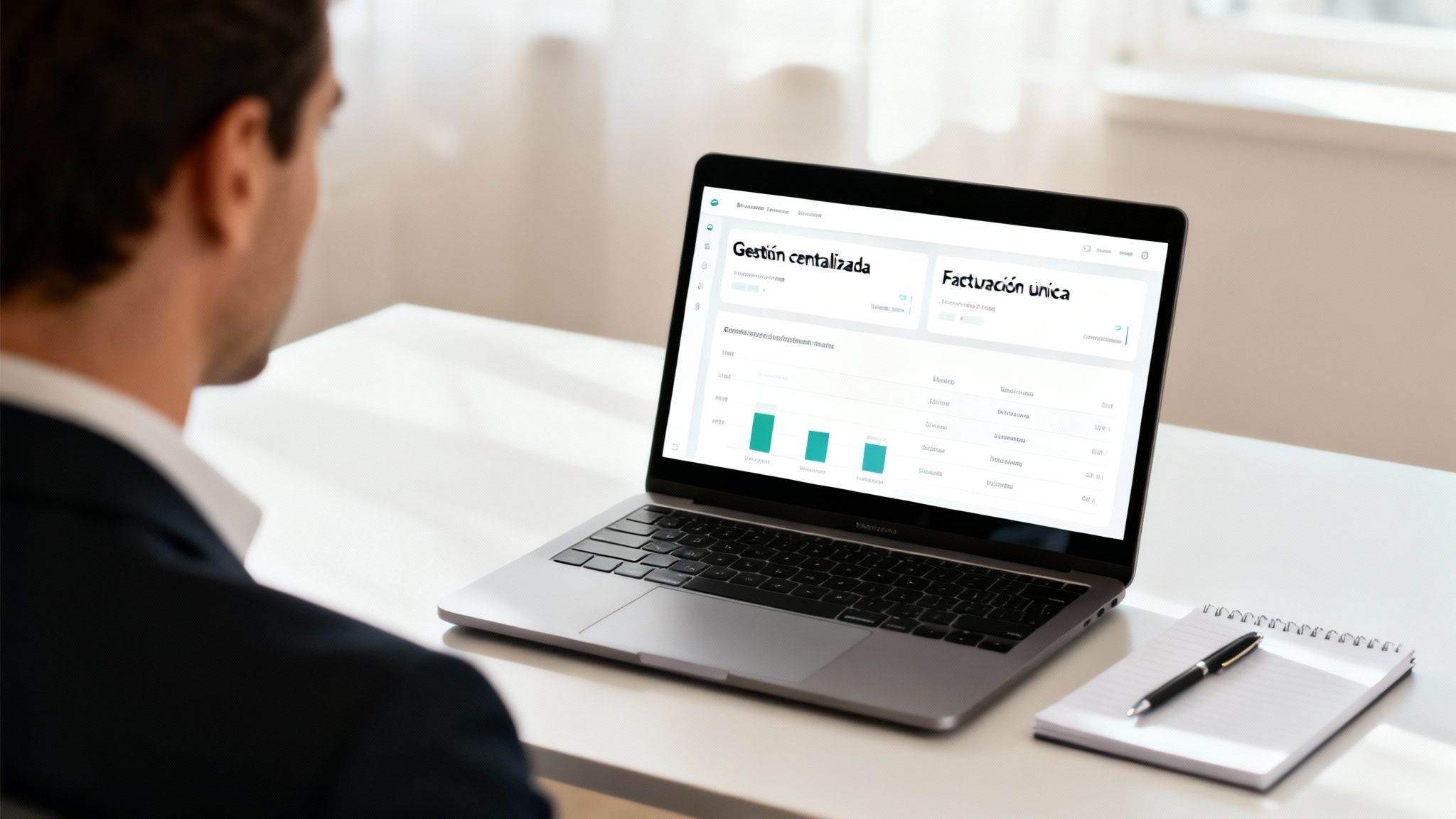 Hombre en una oficina mirando una laptop con un panel de control de negocios y gráficos.