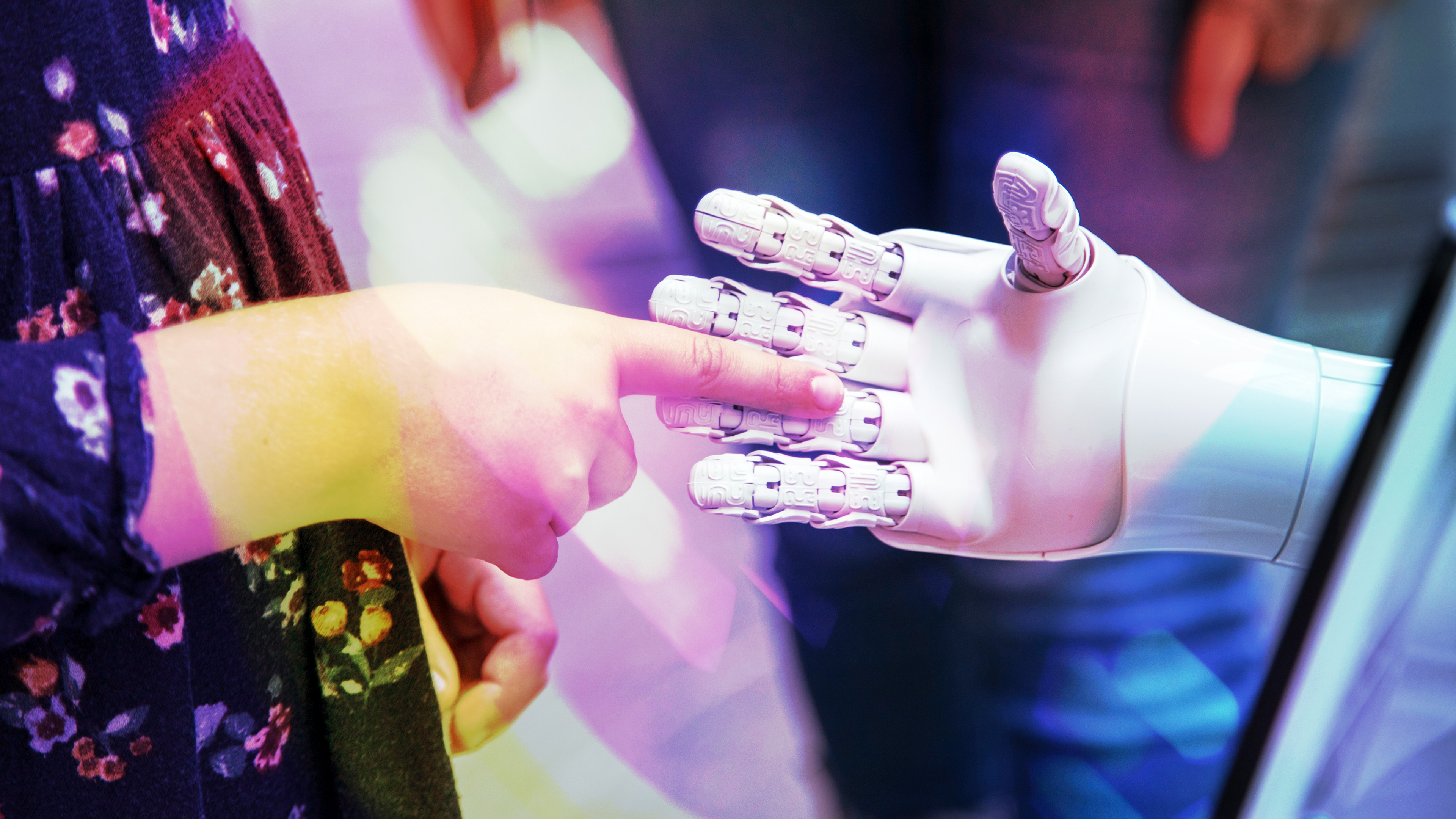 A human and robot hand coming shaking hands