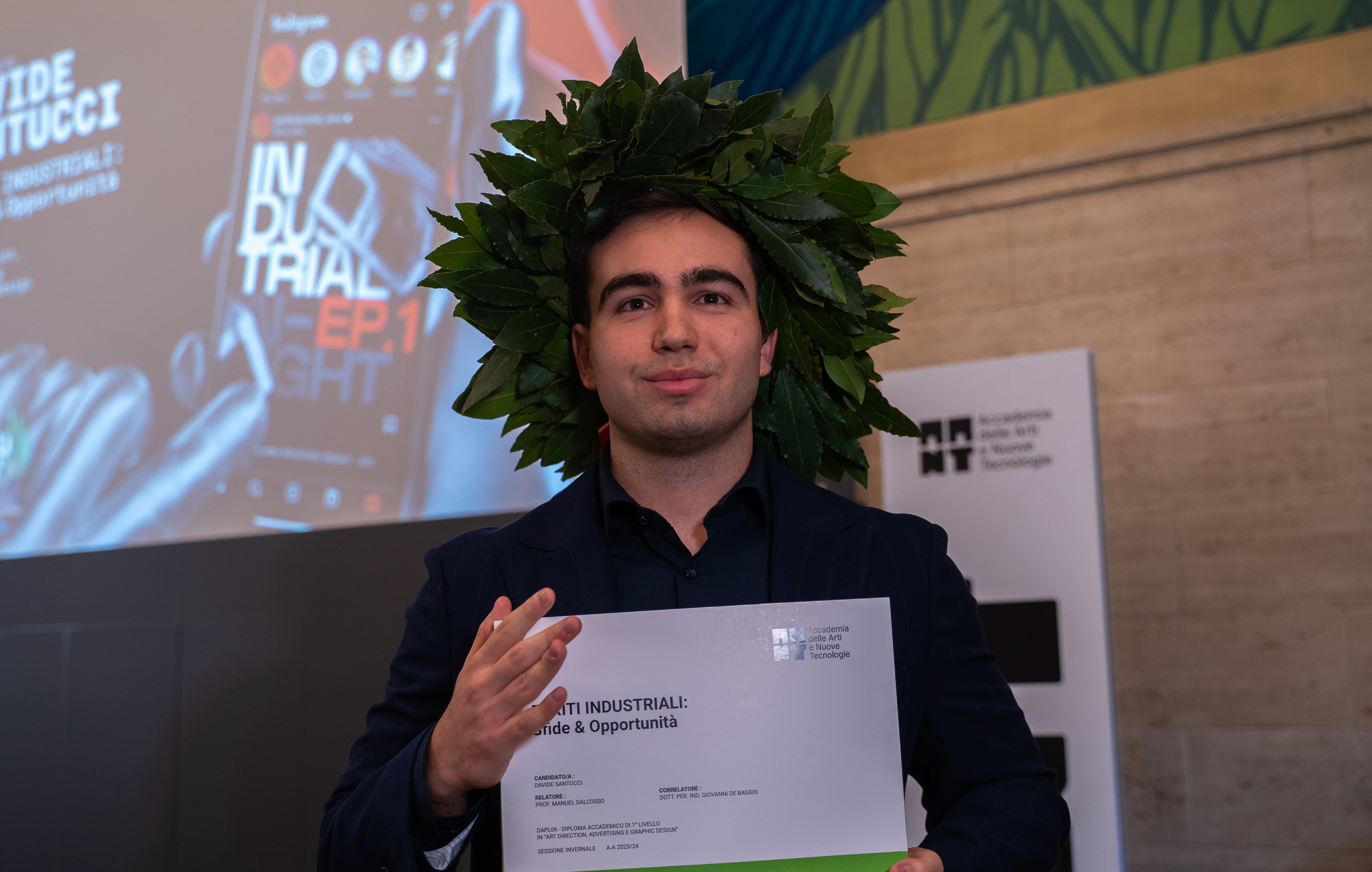 Portrait of man looking to the left and smiling with a dark background
