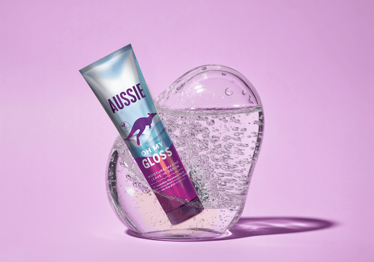 White branded cap with turquoise logo placed on fresh lemons in a red bowl