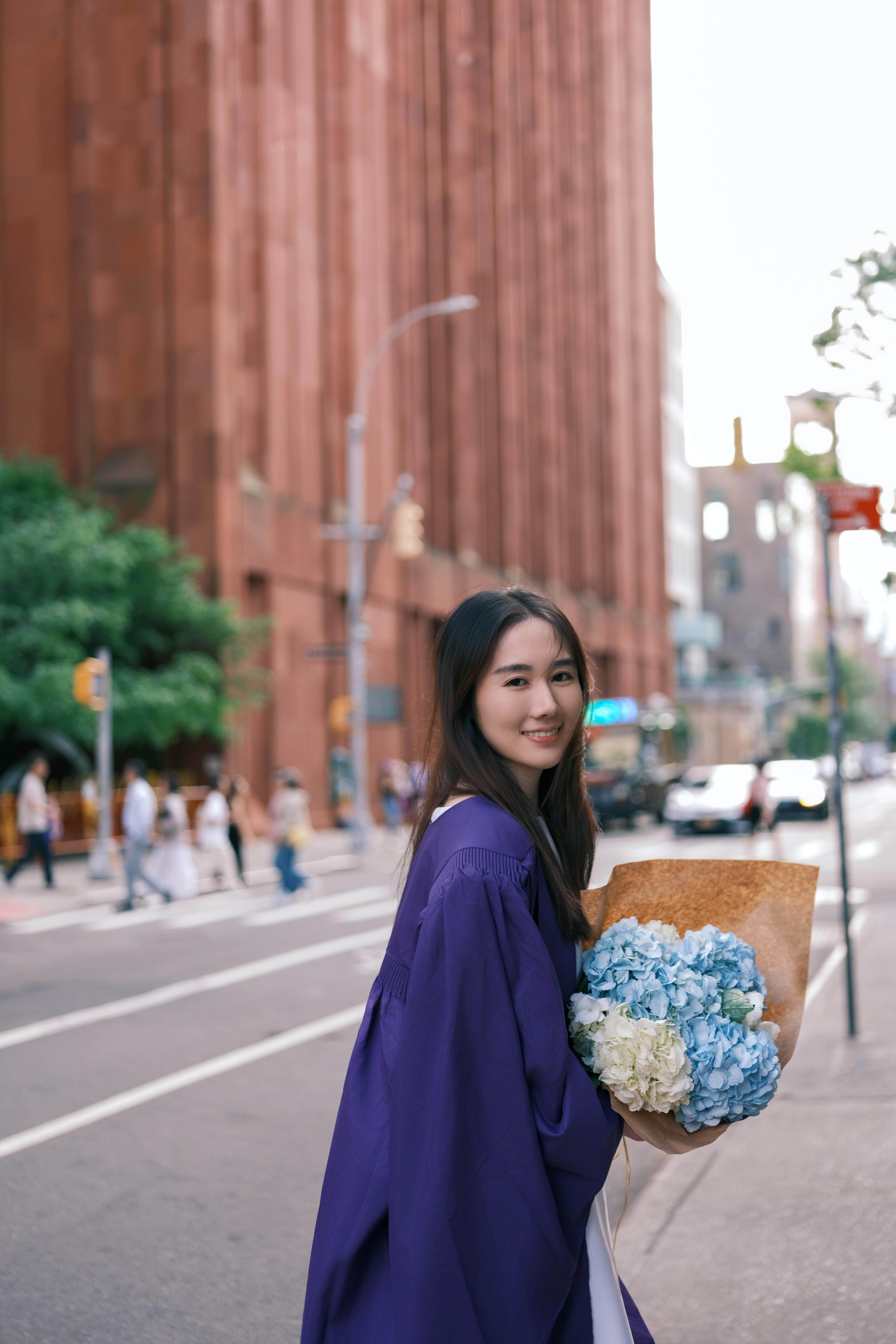 Close-up portrait of a smiling woman with long brown hair