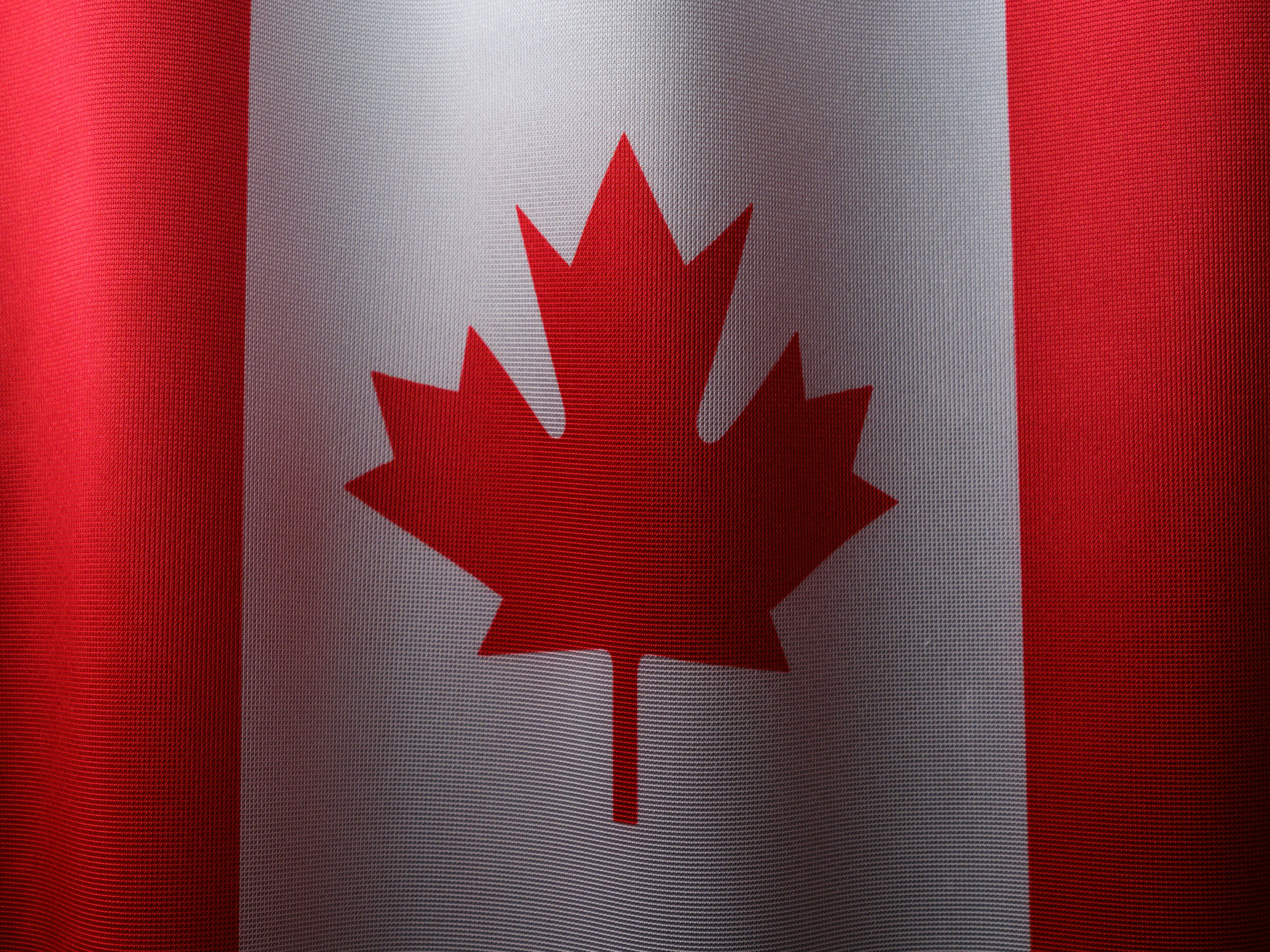 a canadian flag with a red maple leaf on it