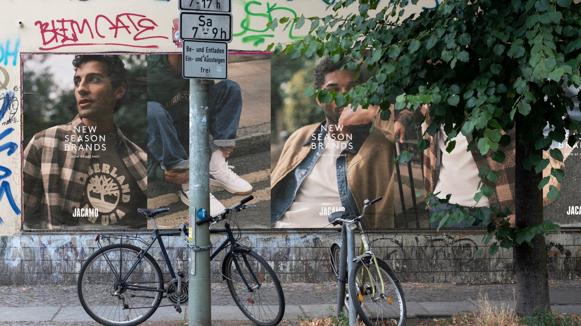 Streetside billboard with flyposters of the Batch.Works brand and illustrations
