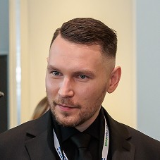Portrait of Lizaveta Hancharenka - Co-Founder & CPO, young woman with long wavy brown hair, wearing a black blazer. She is looking directly at the camera.