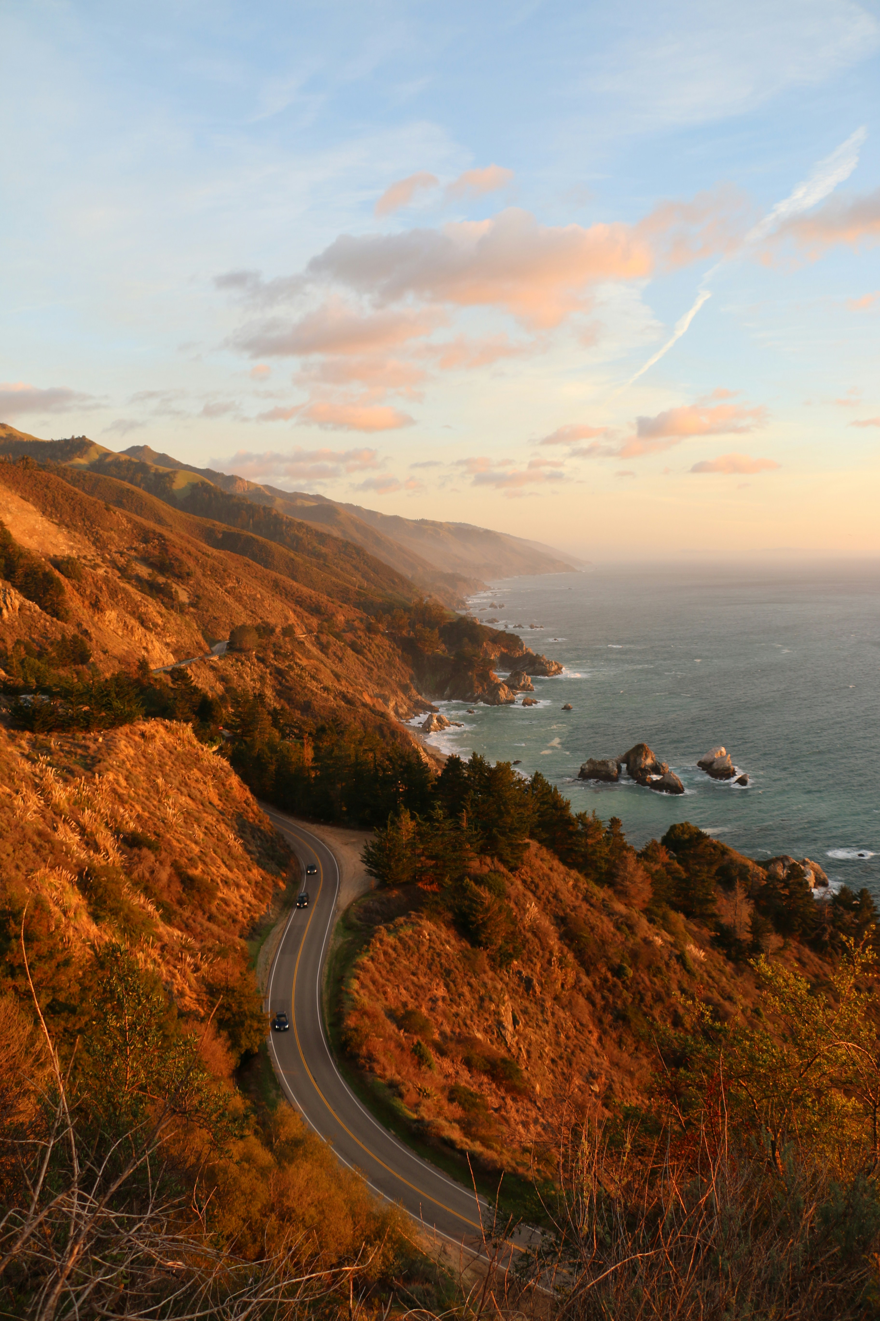 bird's eye photography of road near ocean in california the image symbolizes safety and the feeling of being heard and held in a therapy session at expansive therapy exploring LGBTQ identity therapy.