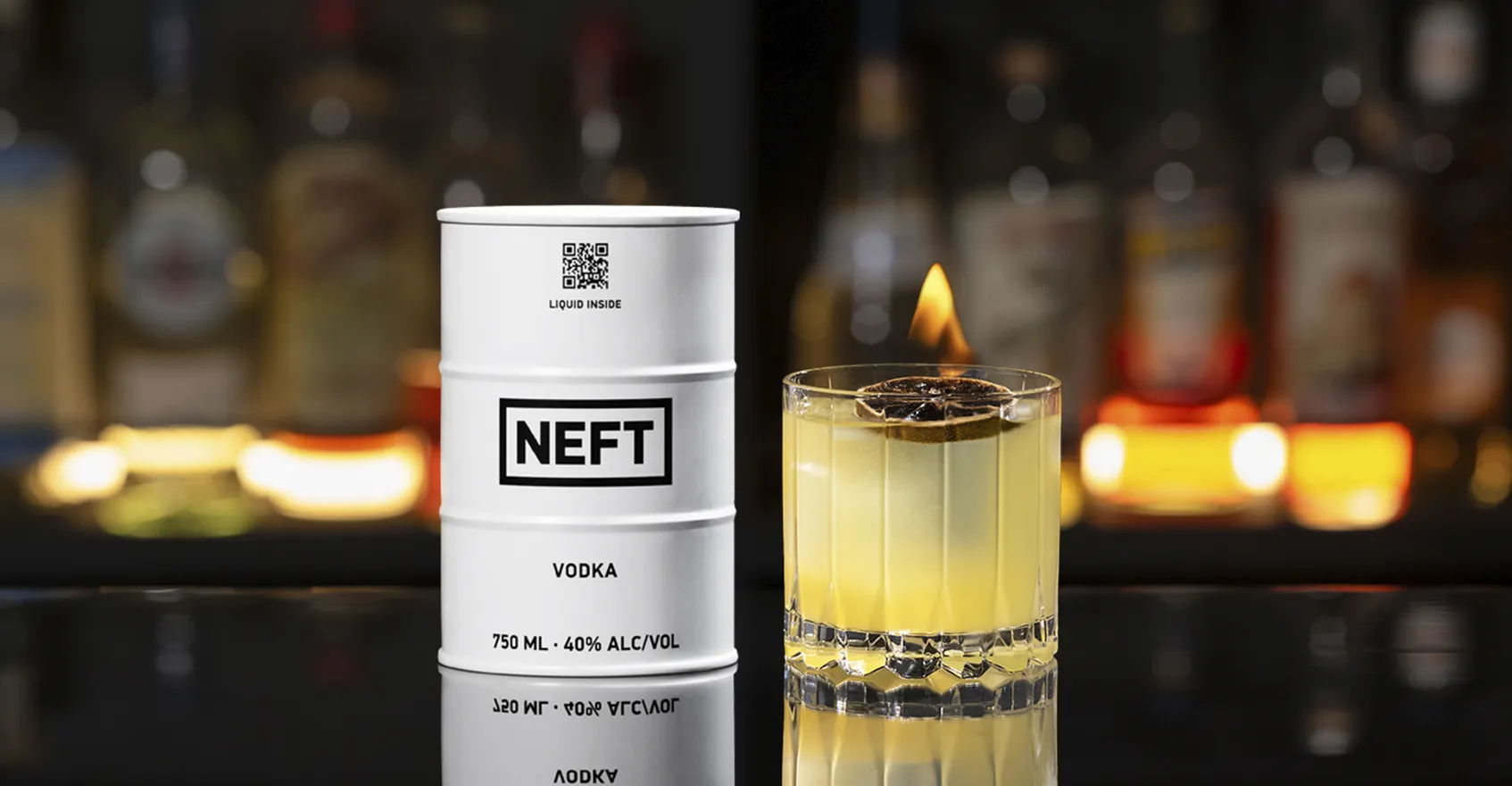 A NEFT Barrel and a glass of My Clementine on a bar counter.