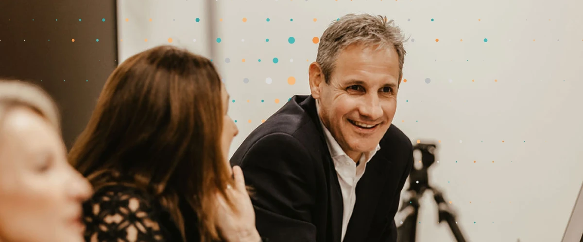 consultant smiling in meeting with other team members