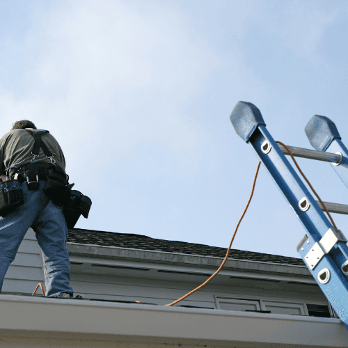 Mammoth Lights expert team member installing Christmas lights safely on a roof