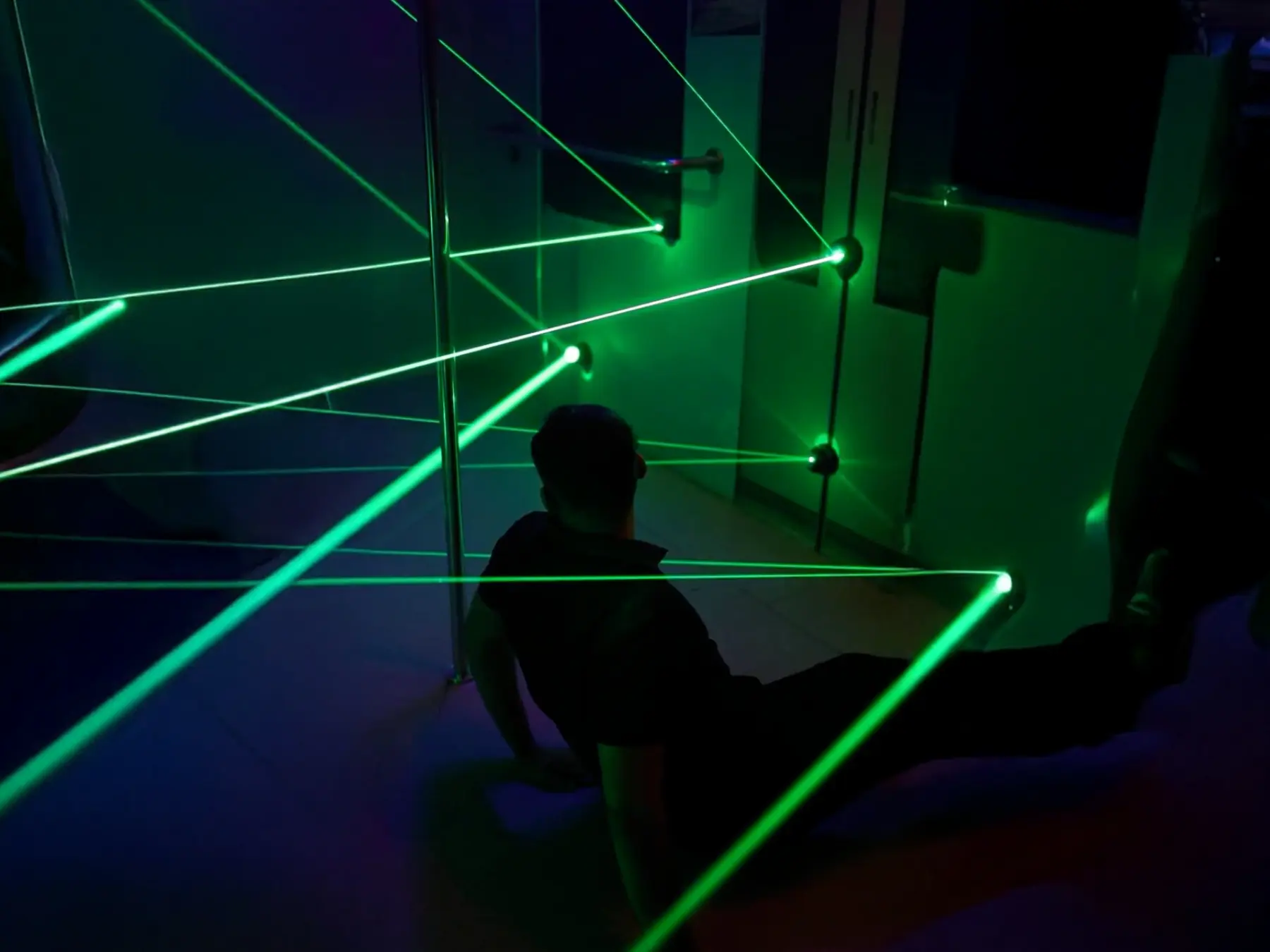 Player displaying competitive spirit by crossing laser beams in escape game