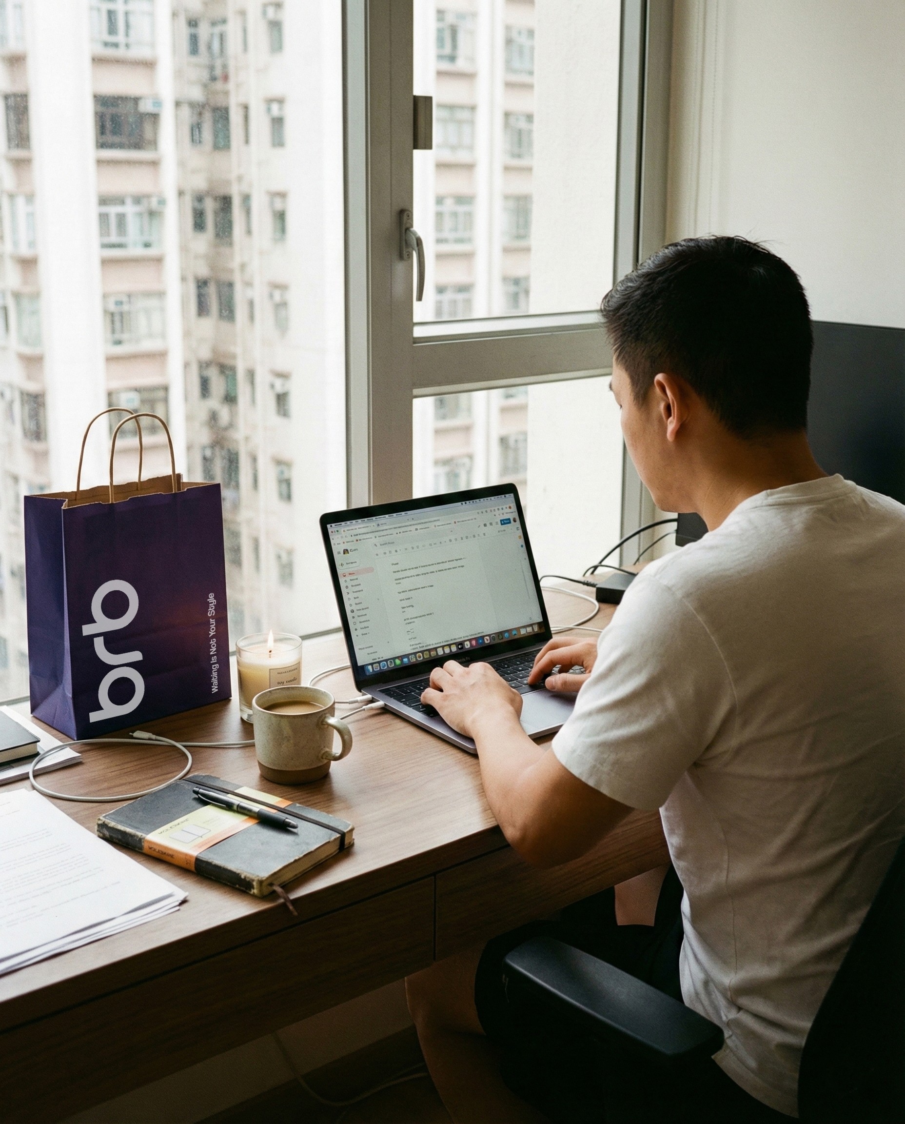 Young woman relaxing at a coffee shop with a BRB bag on table, symbolizing self-care delivery experience