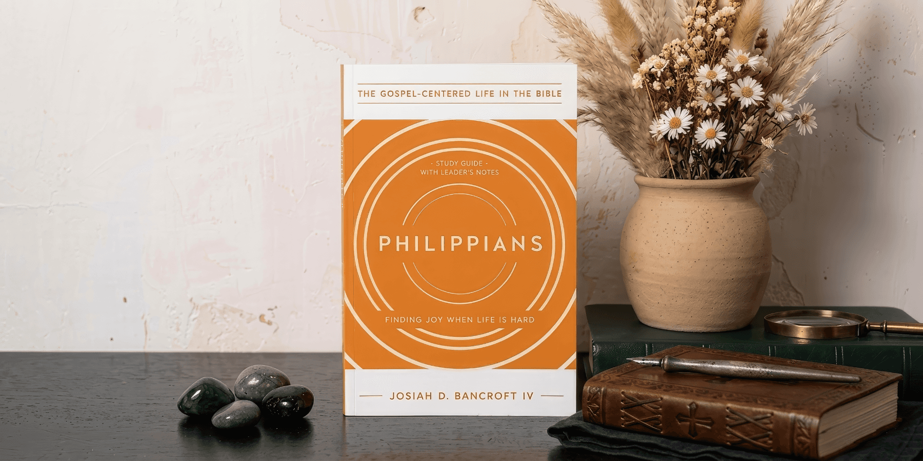 Orange Philippians study book on a desk
