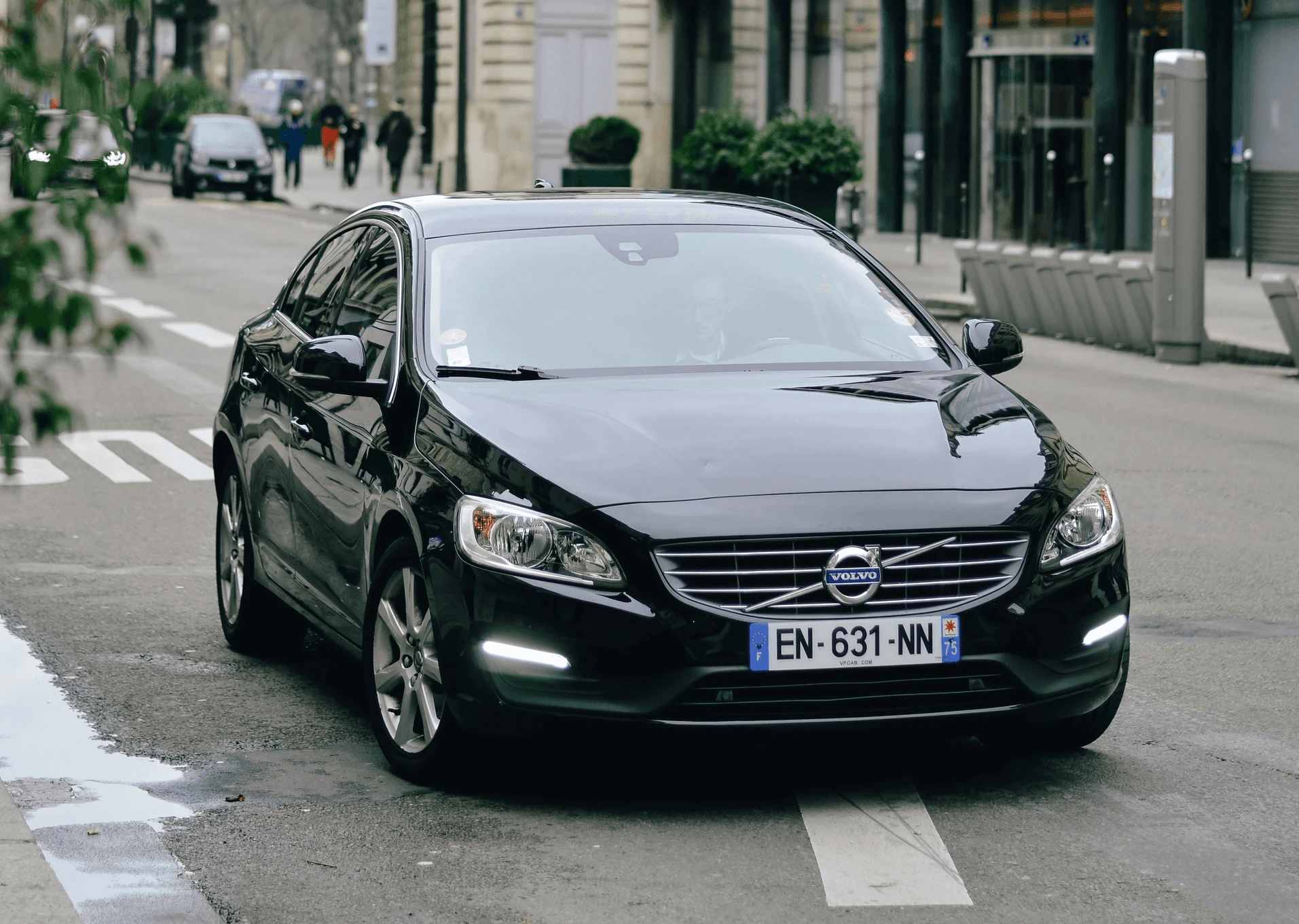 black Volvo S-series sedan on road during daytime