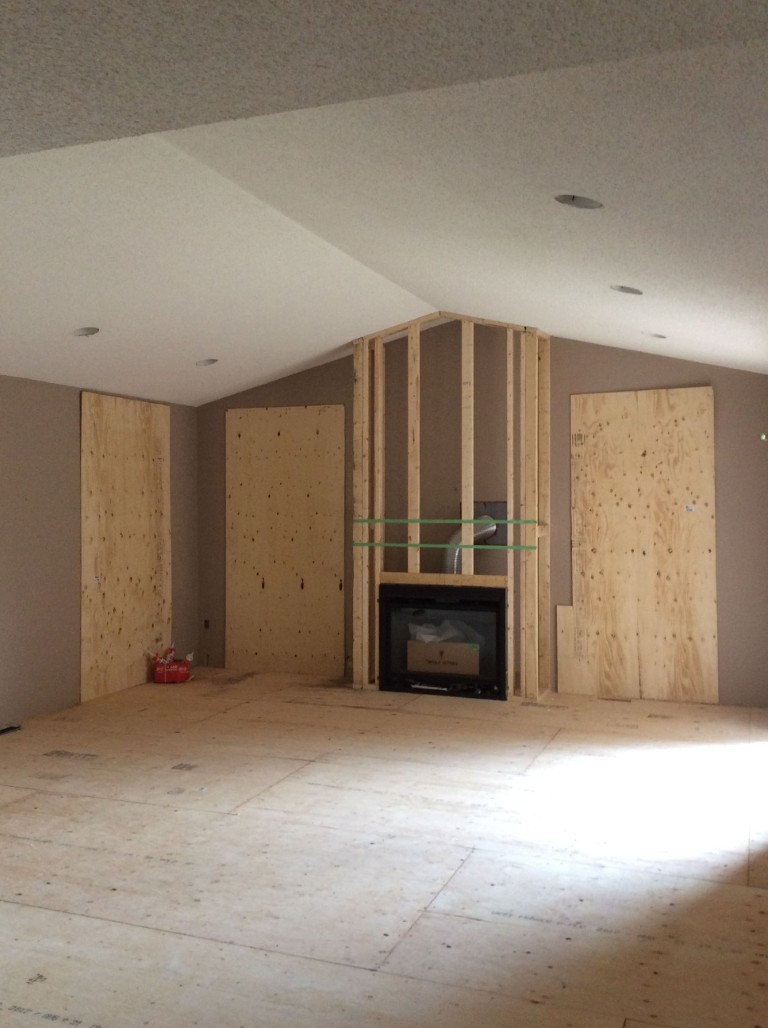 Image of KHD Homes construction project with exposed wooden framing and unfinished interior design elements, layout design underway.