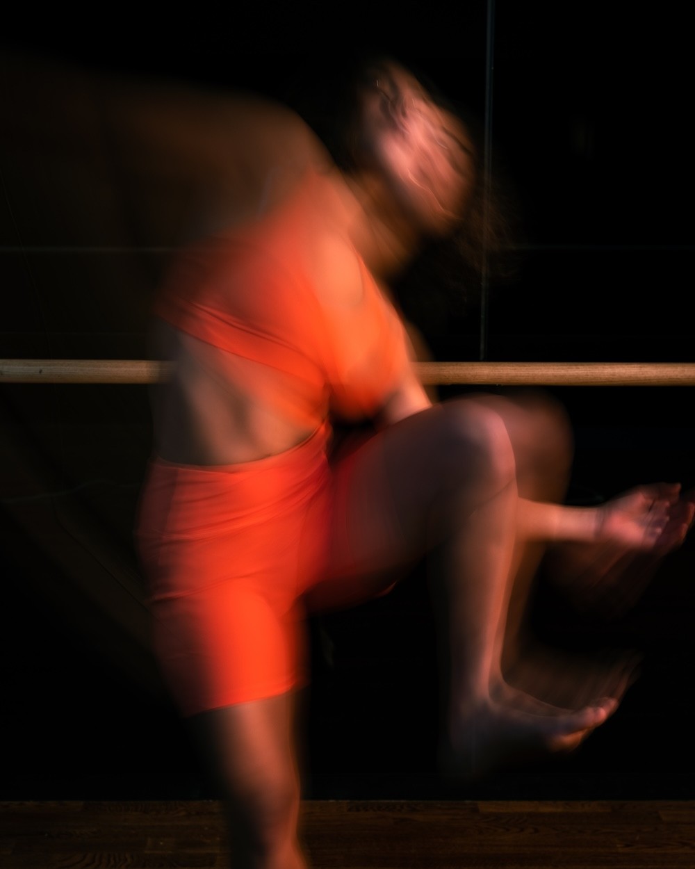 Black cosmetic product bottle against a dark background